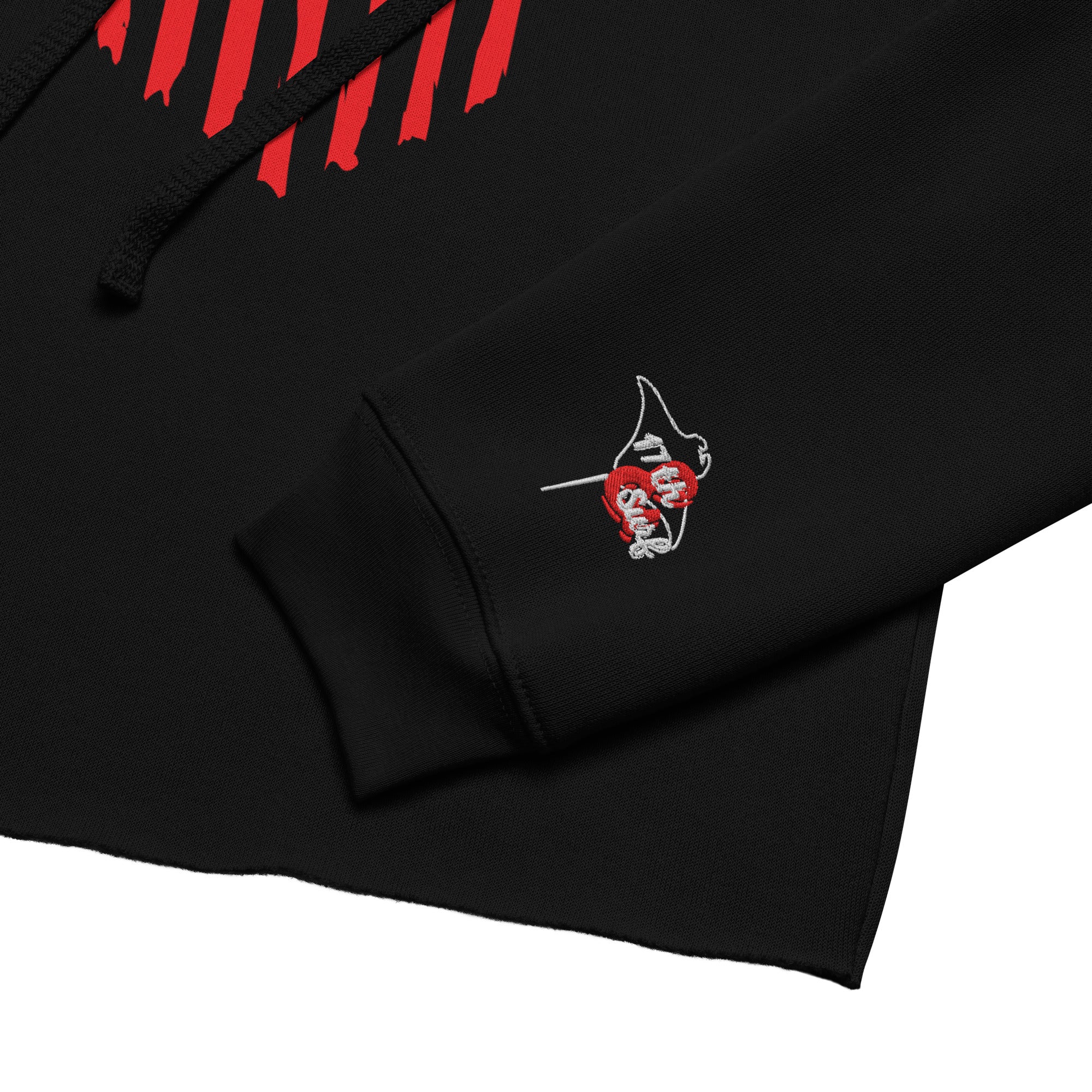 Close-up of the embroidered '17th & Surf' logo with red heart-shaped flag design on the sleeve cuff of the black "1776 & Surf" crop hoodie – America's 250th Anniversary Collection by 17th & Surf
