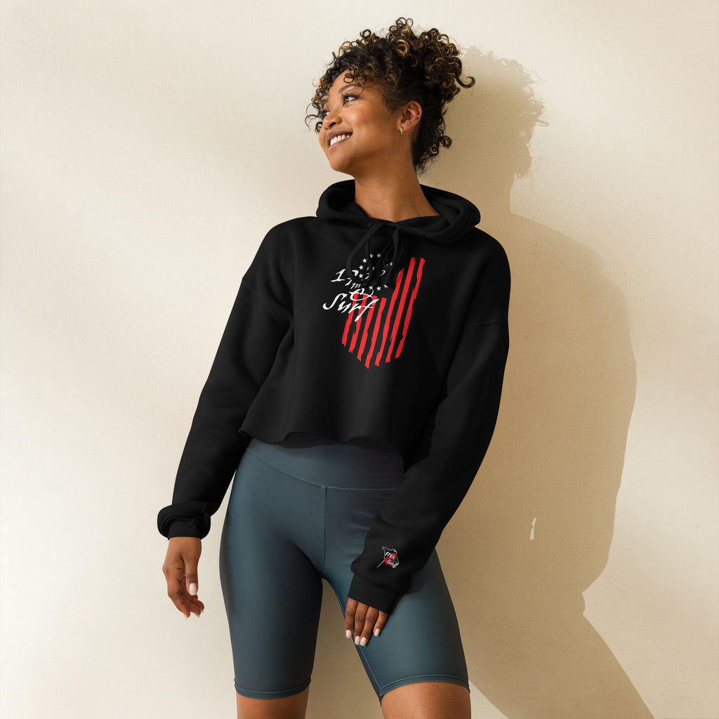 Woman wearing the black "1776 & Surf" crop hoodie, front view, featuring the large 1776 script logo with 13-star Betsy Ross flag and distressed red stripe graphic – America's 250th Anniversary Collection by 17th & Surf