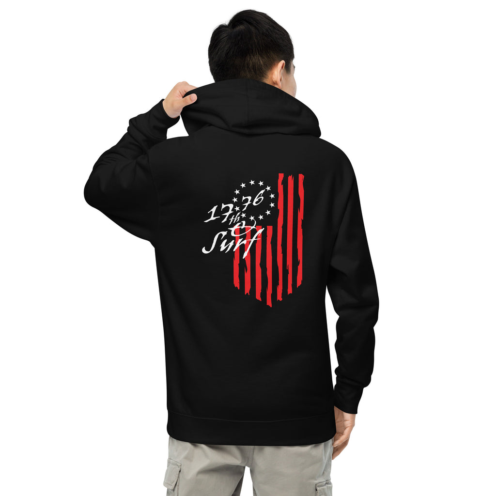 Man wearing the black "1776 & Surf" hoodie, back view, featuring the large 1776 script logo with 13-star Betsy Ross flag and distressed red stripe graphic – America's 250th Anniversary Collection by 17th & Surf