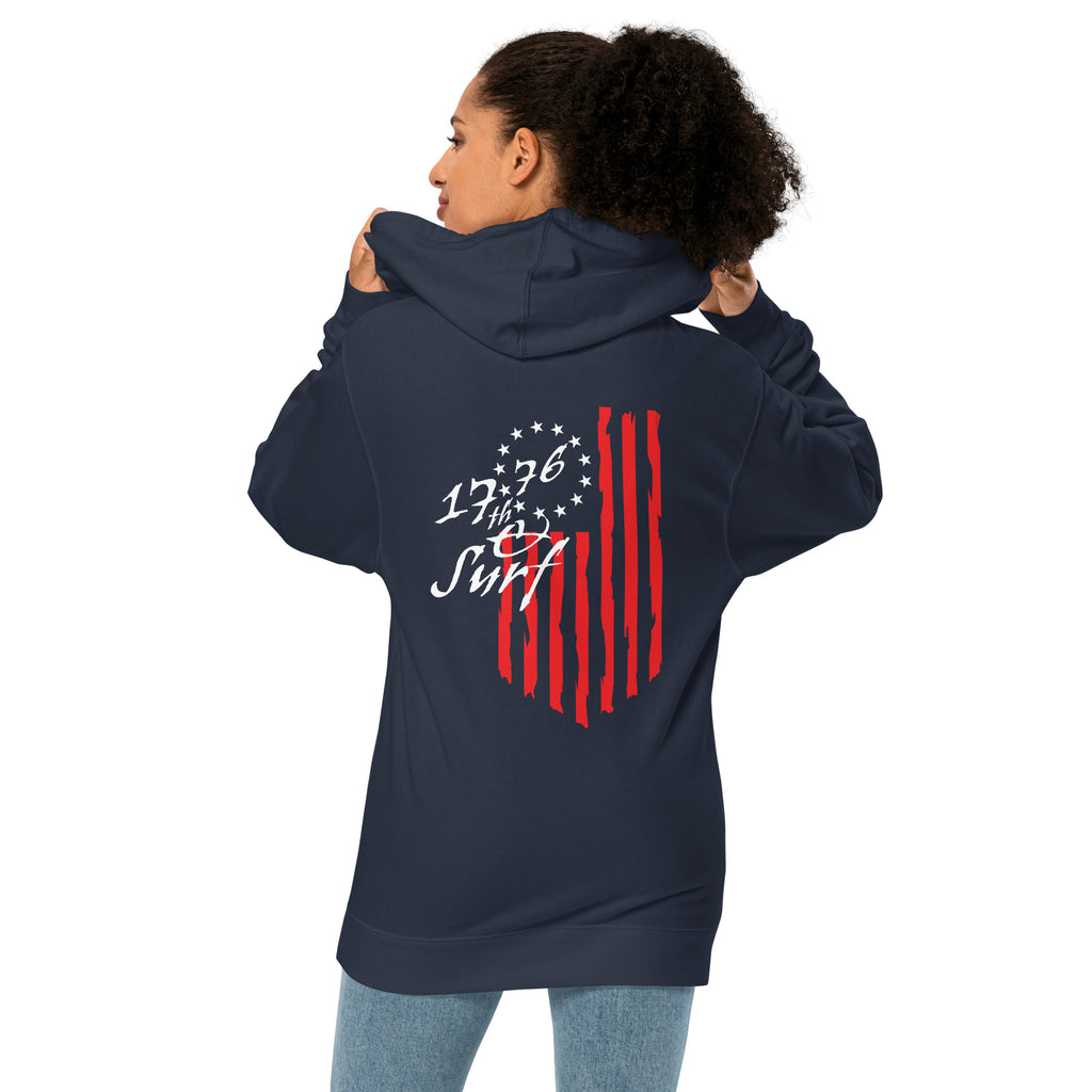 Woman wearing the navy "1776 & Surf" hoodie, back view, featuring the large 1776 script logo with 13-star Betsy Ross flag and distressed red stripe graphic – America's 250th Anniversary Collection by 17th & Surf