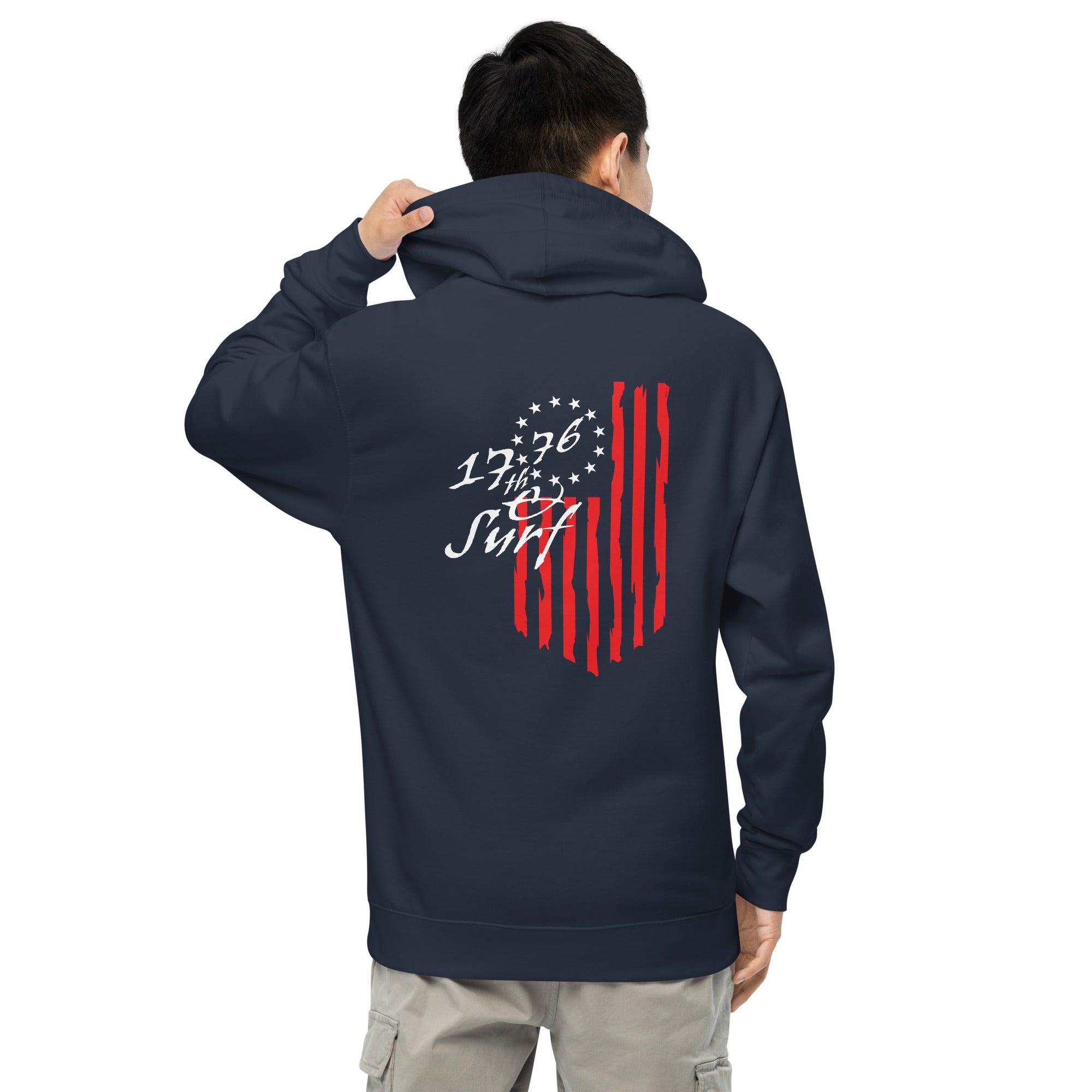 Man wearing the navy "1776 & Surf" hoodie, back view, featuring the large 1776 script logo with 13-star Betsy Ross flag and distressed red stripe graphic – America's 250th Anniversary Collection by 17th & Surf