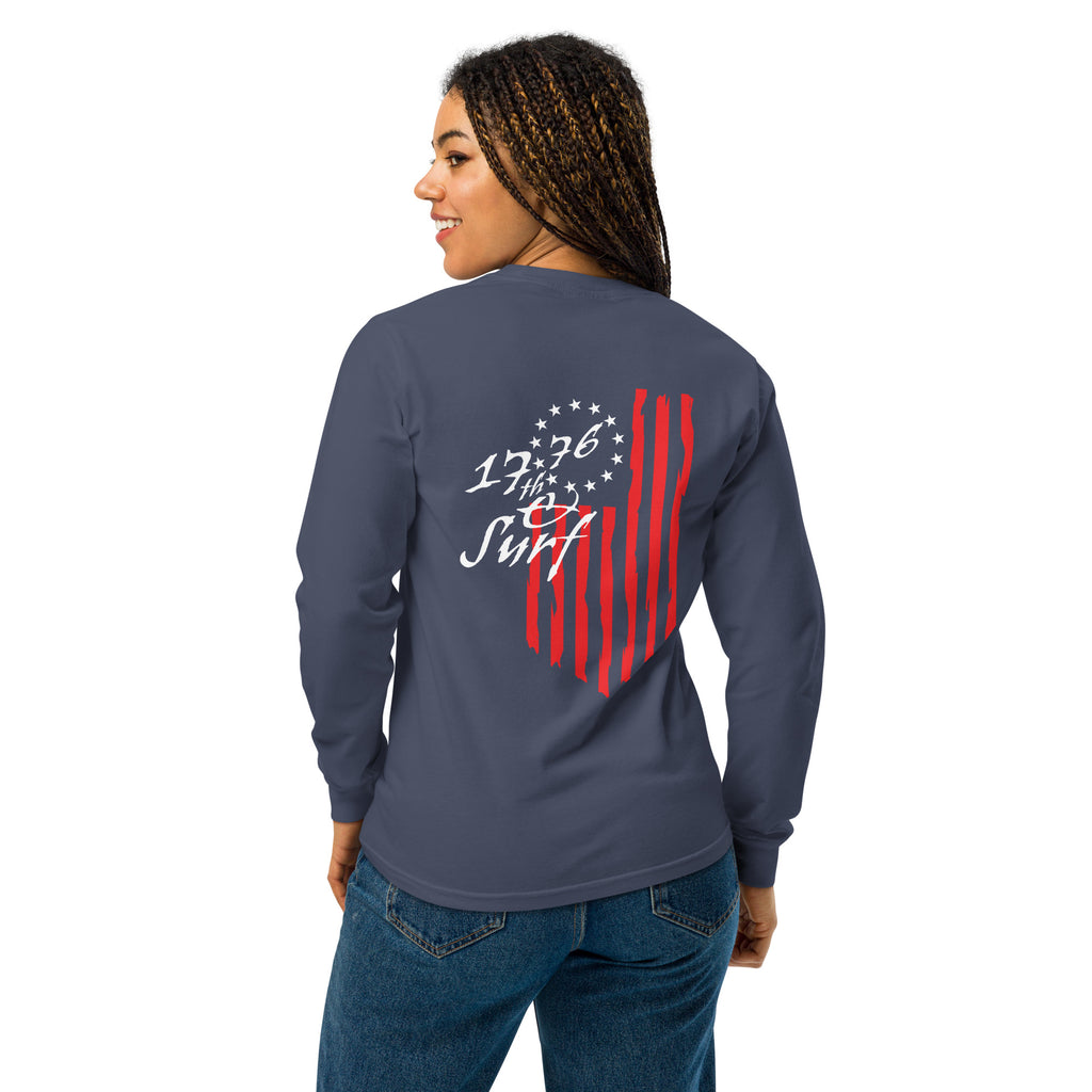 Woman wearing the navy "1776 & Surf" long sleeve shirt, back view, featuring the large 1776 script logo with 13-star Betsy Ross flag and distressed red stripe graphic – America's 250th Anniversary Collection by 17th & Surf
