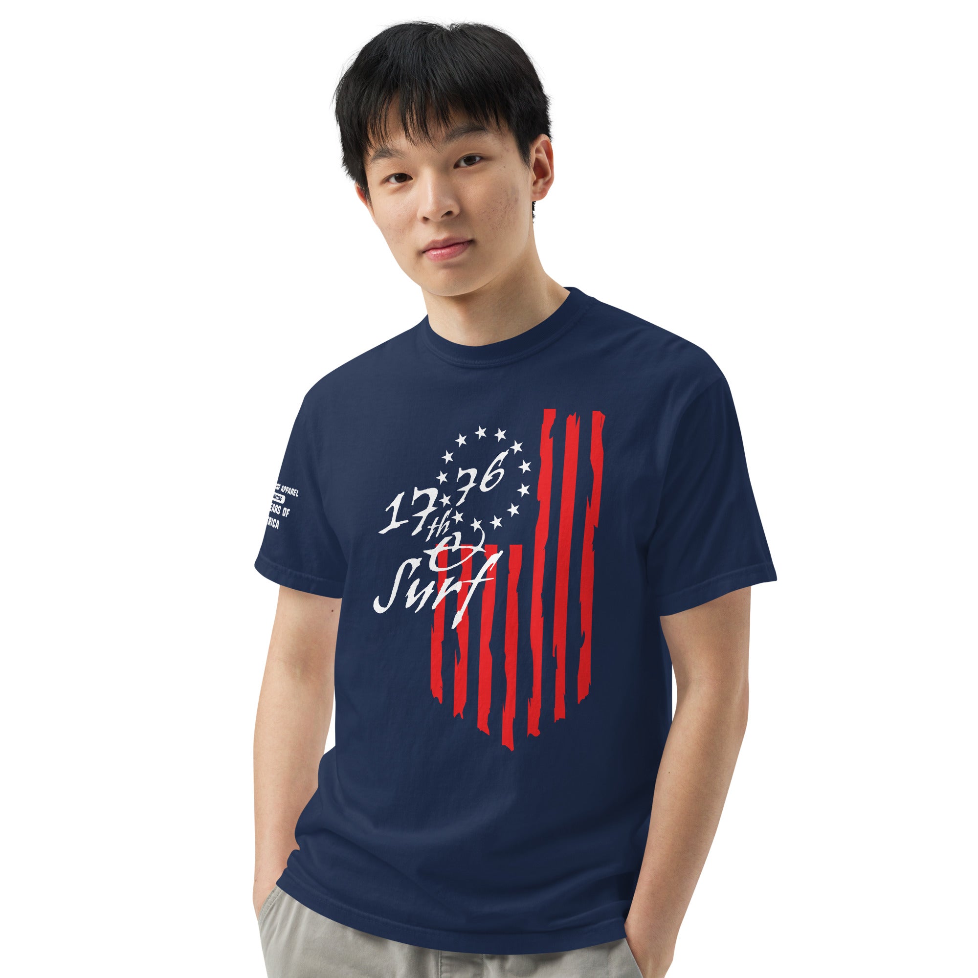 Man wearing the navy "1776 & Surf" tee - front print, front view, featuring the large 1776 script logo with 13-star Betsy Ross flag and distressed red stripe graphic – America's 250th Anniversary Collection by 17th & Surf