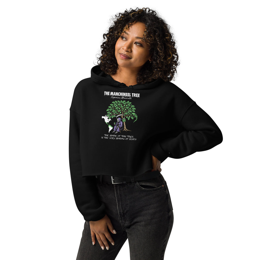 "Beach Apple" black cropped hoodie, front view on female model, featuring the large "THE MANCHINEEL TREE" graphic with the Grim Reaper, green iguana, "DANGER POISON" sign, and map of Central/South America – "Beach Apple" Series by 17th & Surf