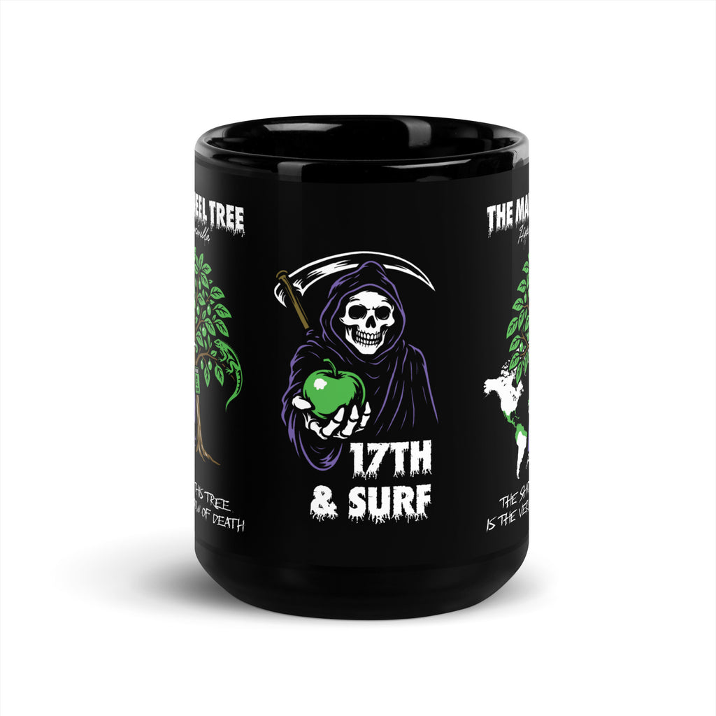 "Beach Apple" black glossy 15oz mug, front view, featuring the small "17th & Surf" Grim Reaper apple logo centered between the wraparound "THE MANCHINEEL TREE" graphic panels – "Beach Apple" Series by 17th & Surf