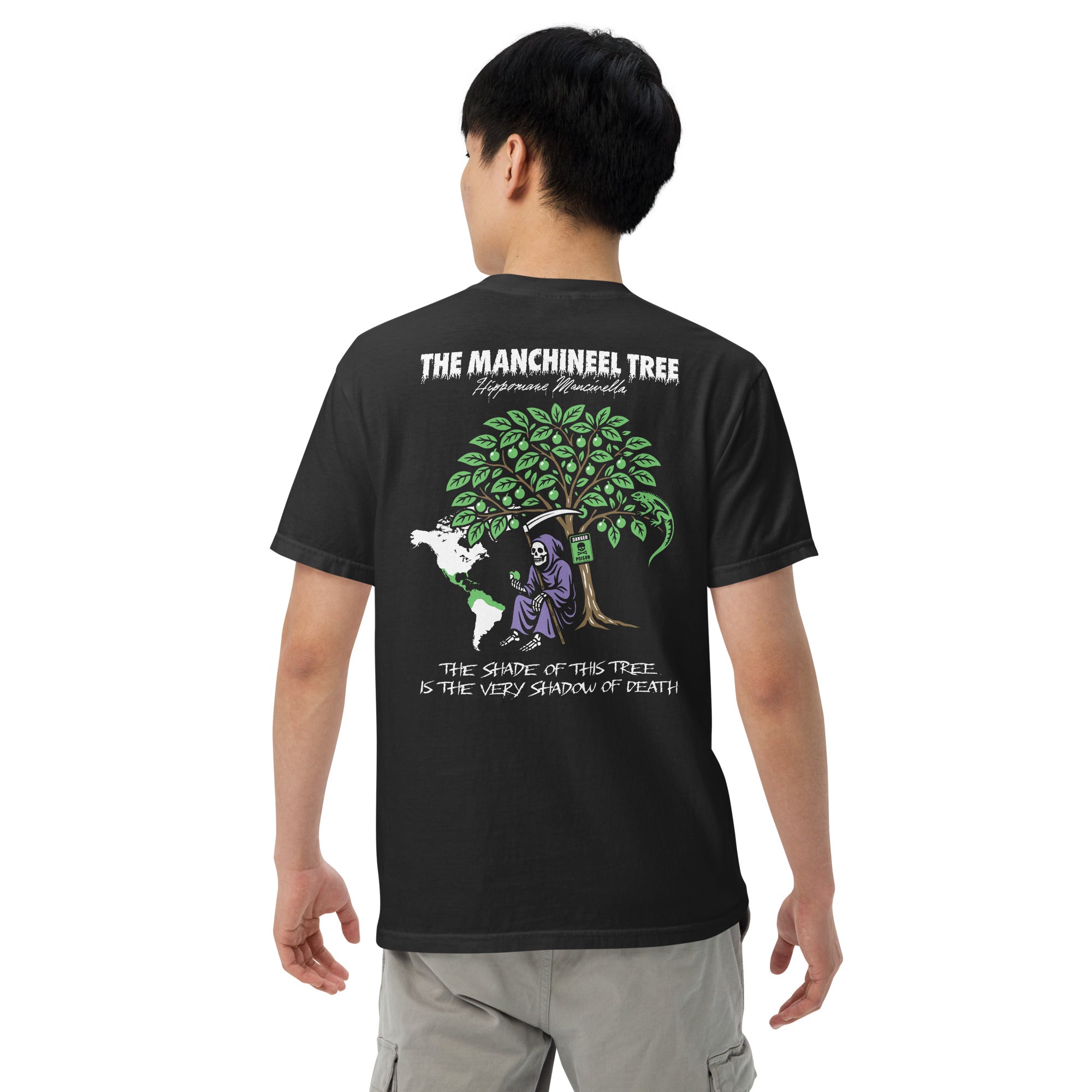 "Beach Apple" garment-dyed heavyweight tee, back view on male model, featuring the large "THE MANCHINEEL TREE" graphic with the Grim Reaper, green iguana, "DANGER POISON" sign, and map of Central/South America – "Beach Apple" Series by 17th & Surf