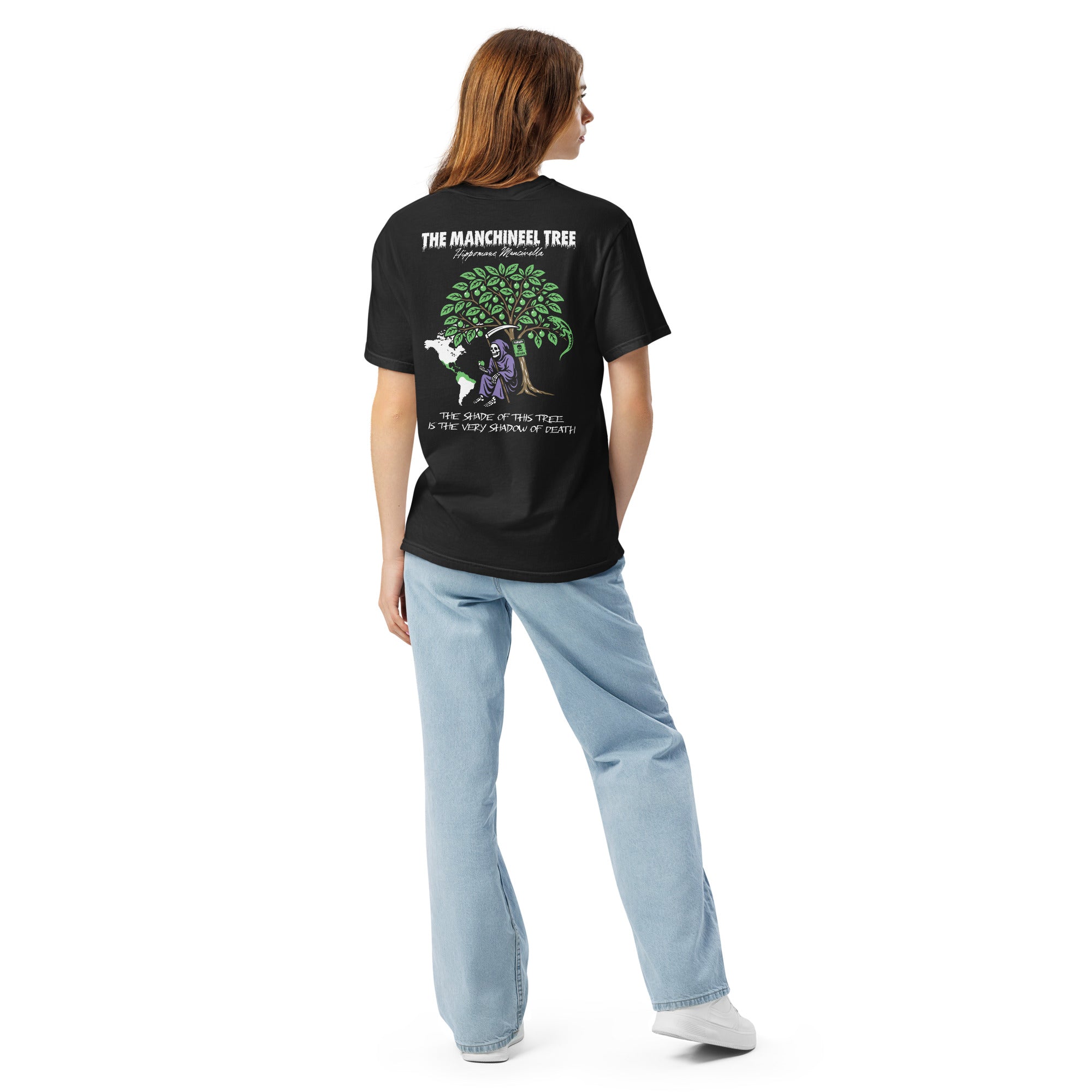 "Beach Apple" garment-dyed heavyweight tee, back view on female model, featuring the large "THE MANCHINEEL TREE" graphic with the Grim Reaper, green iguana, "DANGER POISON" sign, and map of Central/South America – "Beach Apple" Series by 17th & Surf