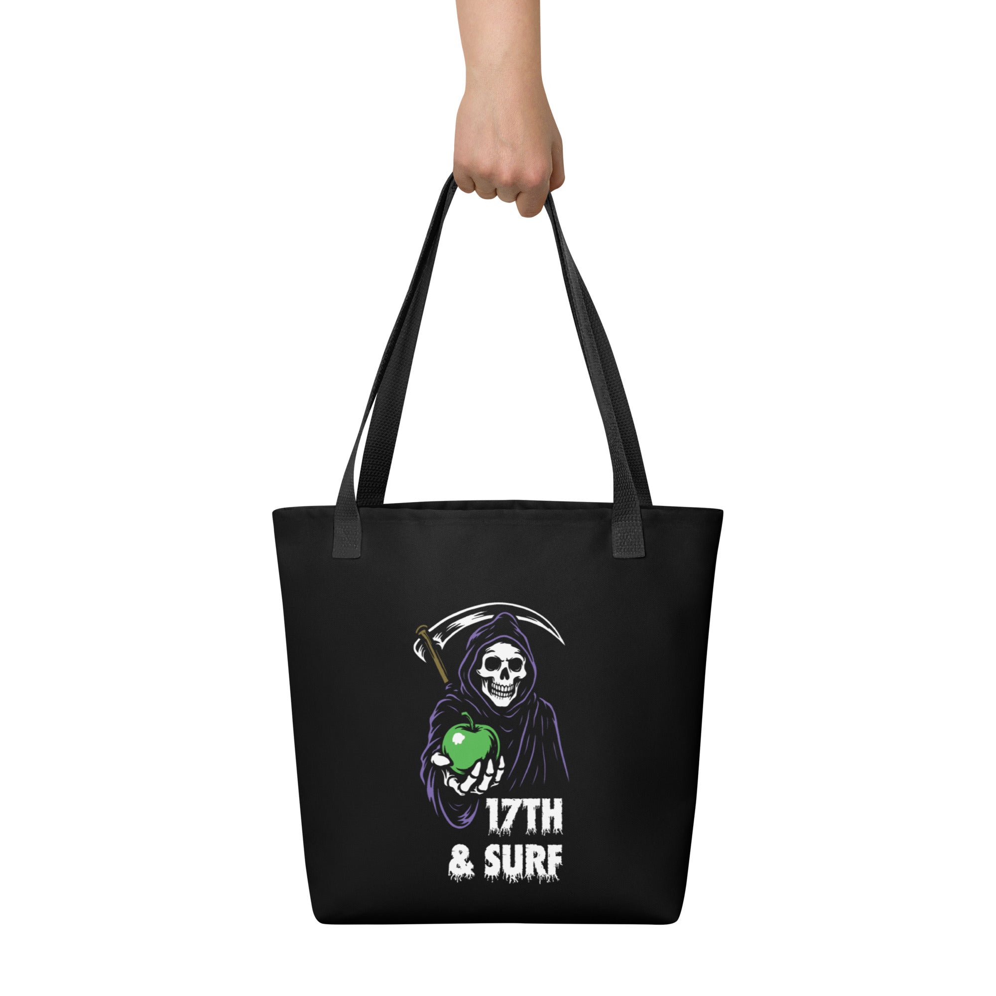 "Beach Apple" black canvas tote bag, back view on model, featuring the small "17th & Surf" Grim Reaper apple logo – "Beach Apple" Series by 17th & Surf