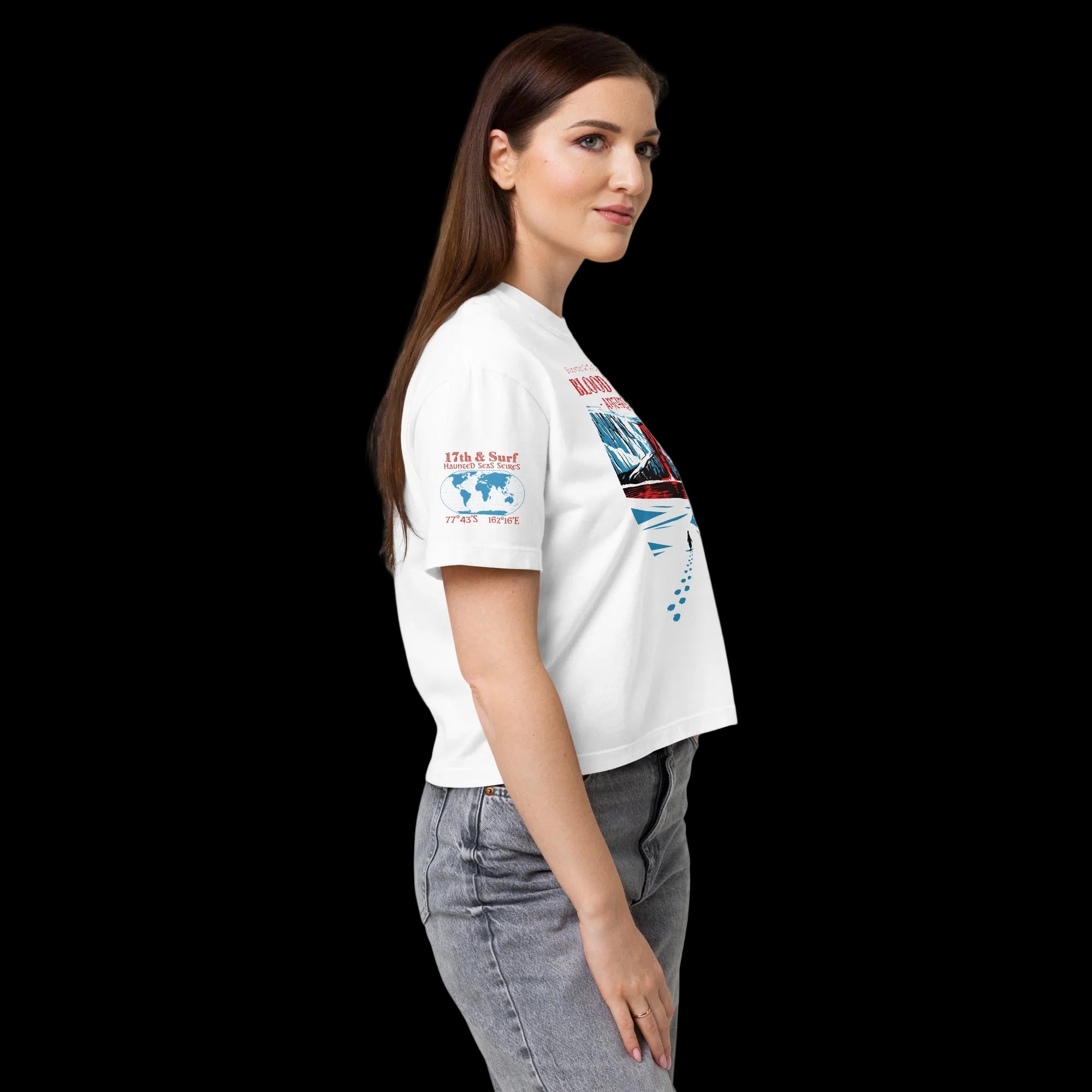 Side profile of model in white women’s heavyweight boxy tee featuring Haunted Seas sleeve graphic with coordinates 77°43'S 162°16'E
