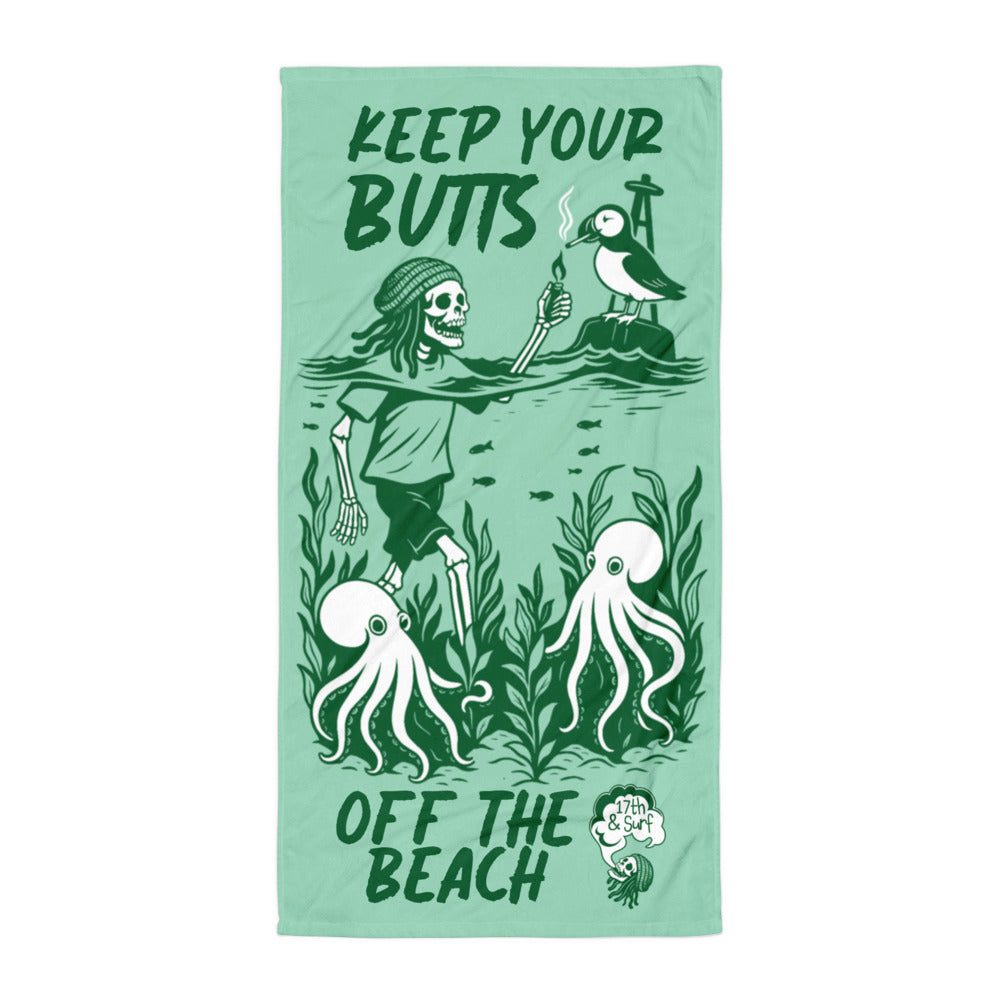 "Keep Your Butts Off The Beach" beach towel flat lay featuring skeleton lighting a cigarette for a puffin with octopuses in seaweed and "Keep Your Butts Off The Beach" text in green on white background - 17th & Surf