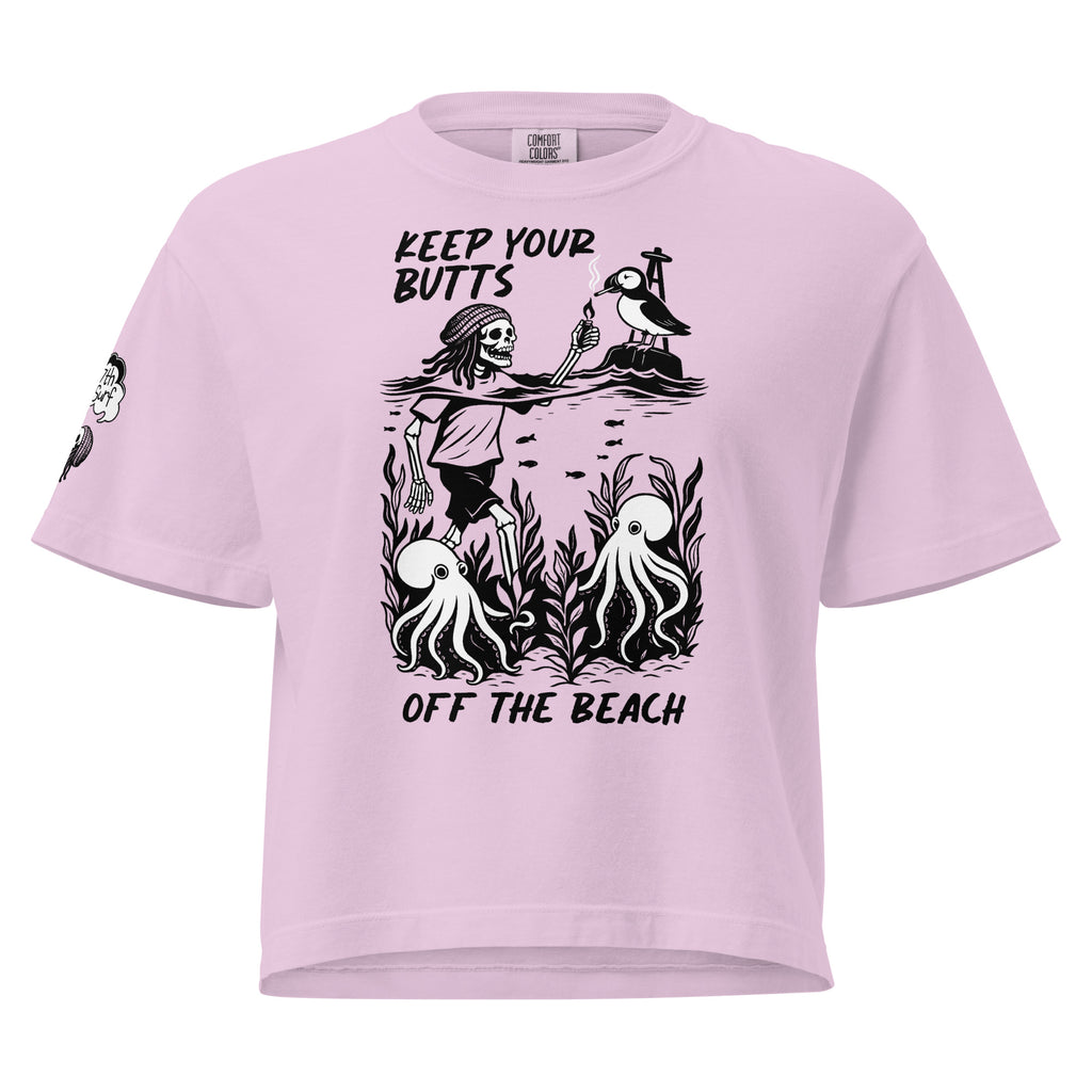 "Keep Your Butts Off The Beach" women's heavyweight boxy tee front view in orchid pink featuring skeleton lighting a cigarette for a puffin with octopuses in seaweed graphic and small smoking-skull sleeve logo - 17th & Surf