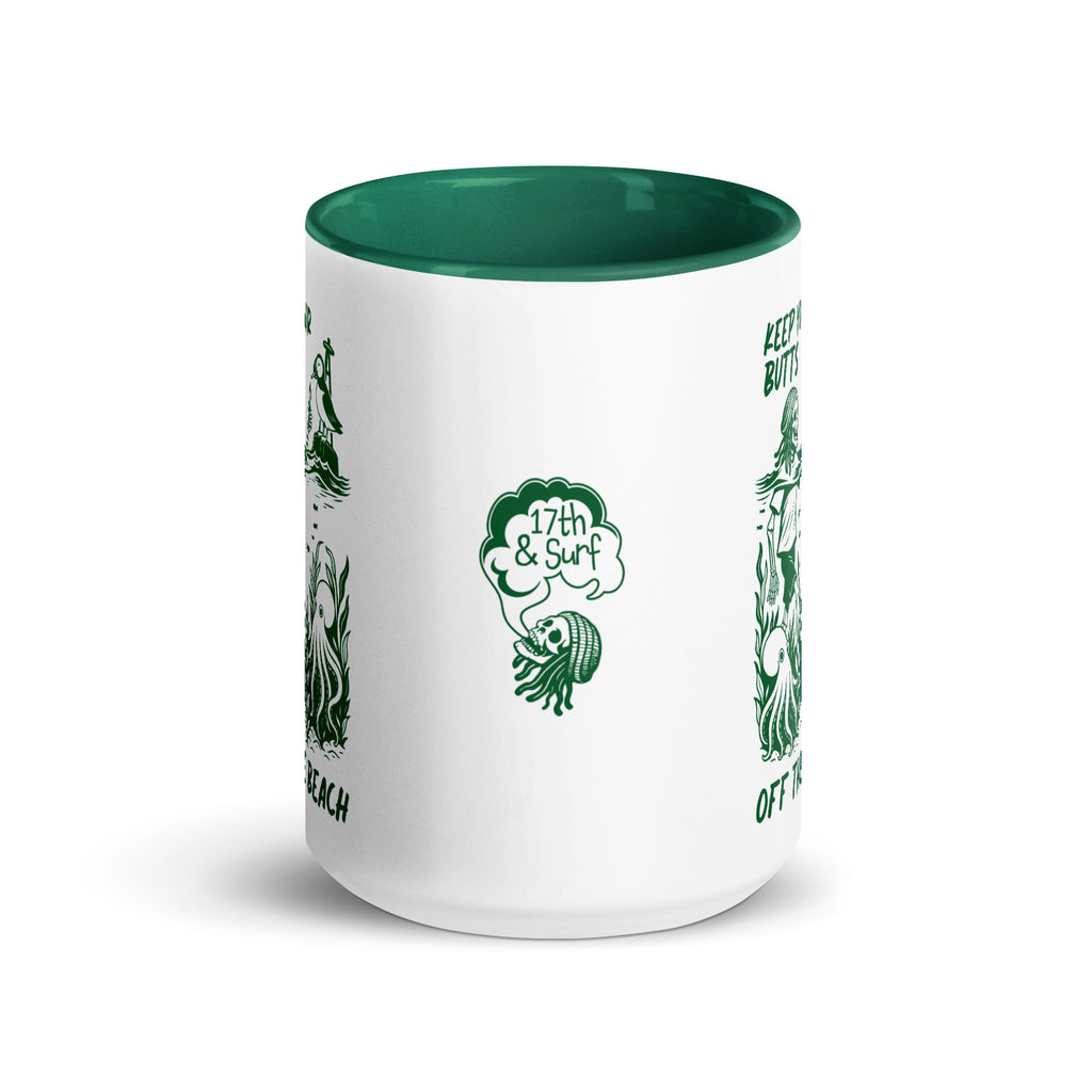 "Keep Your Butts Off The Beach" white ceramic 15oz mug with dark green interior and handle, front view, featuring "Keep Your Butts Off The Beach" text and skeleton with puffin graphic - 17th & Surf