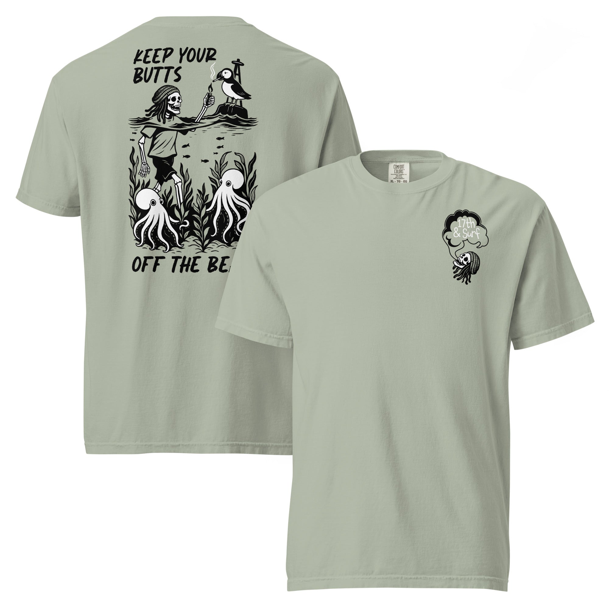 "Keep Your Butts Off The Beach" garment-dyed heavyweight tee in bay, front and back flat lay, featuring a skeleton lighting a cigarette for a puffin with octopuses in seaweed and "Keep Your Butts Off The Beach" text on the back and a small smoking-skull chest logo on the front - 17th & Surf