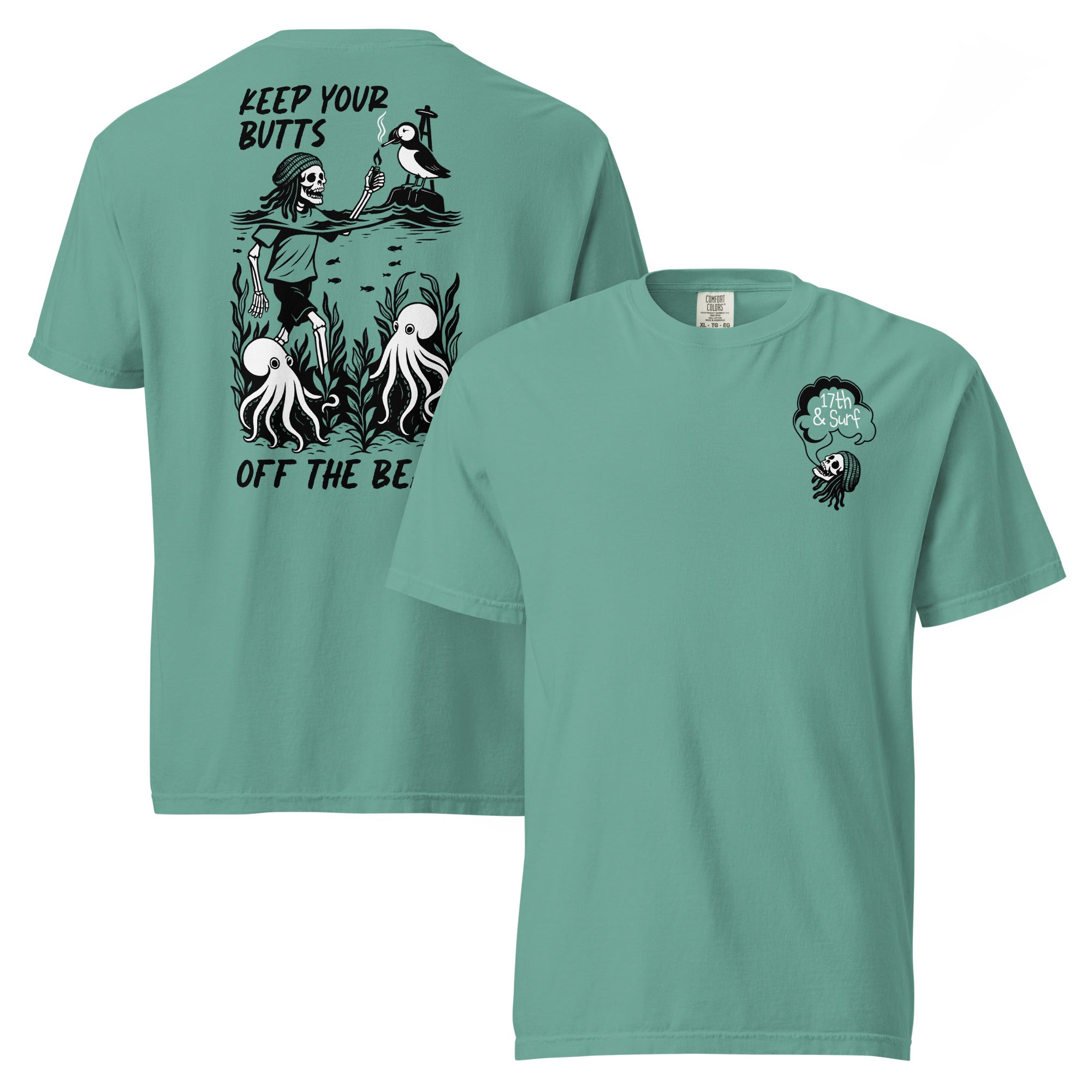 "Keep Your Butts Off The Beach" garment-dyed heavyweight tee in seafoam, front and back flat lay, featuring a skeleton lighting a cigarette for a puffin with octopuses in seaweed and "Keep Your Butts Off The Beach" text on the back and a small smoking-skull chest logo on the front - 17th & Surf