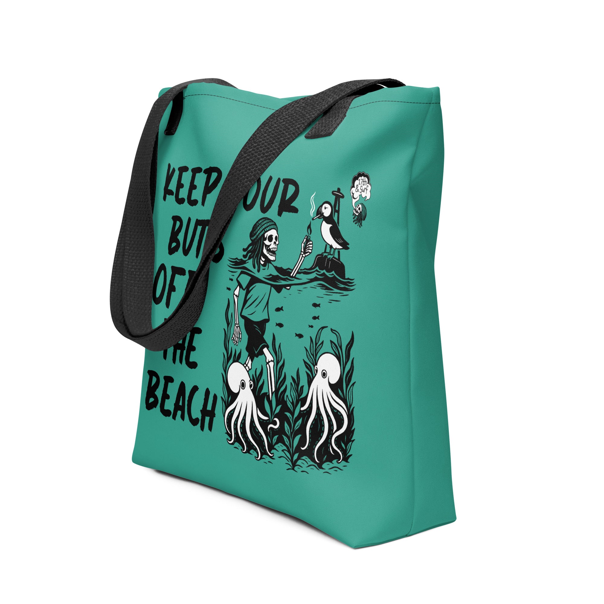 "Keep Your Butts Off The Beach" teal canvas tote bag angled view featuring skeleton lighting a cigarette for a puffin with octopuses in seaweed and "Keep Your Butts Off The Beach" text graphic - 17th & Surf
