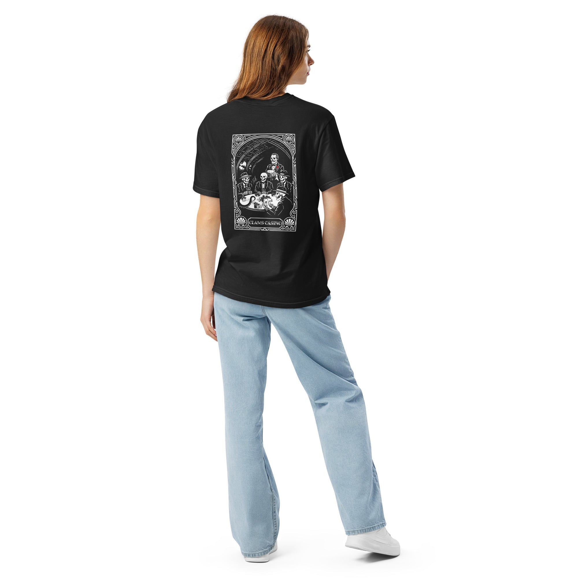 Woman wearing the "Clams Casino" ivory heavyweight tee, back view, featuring the large art nouveau "CLAMS CASINO" poker scene with skeleton mobsters, a tuxedo-clad Don holding a catfish, and an octopus tentacle reaching across the table – Clam's Casino Series by 17th & Surf