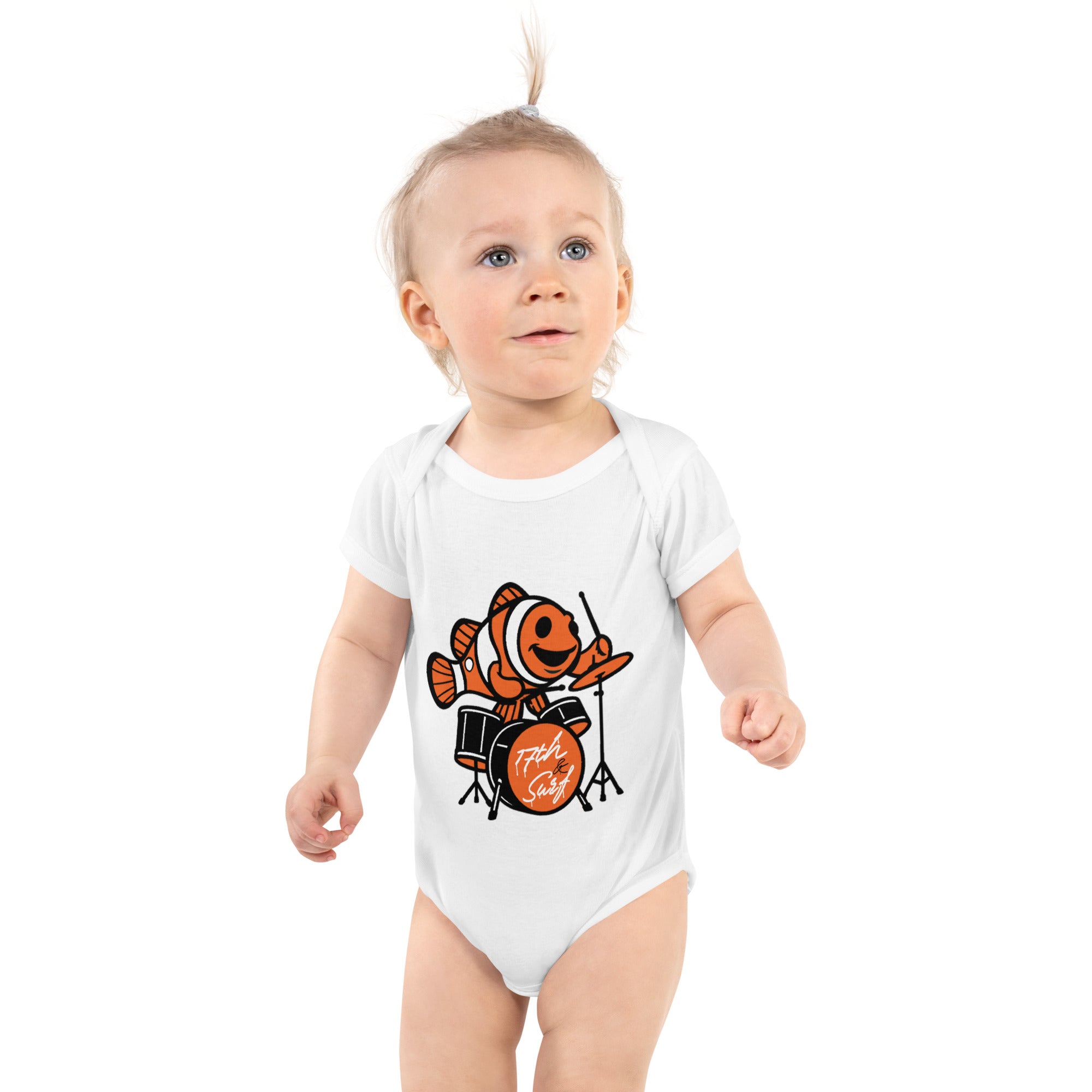Baby wearing a white short sleeve onesie featuring an orange clownfish playing drums with the "17th & Surf" logo on the bass drum – 17th & Surf