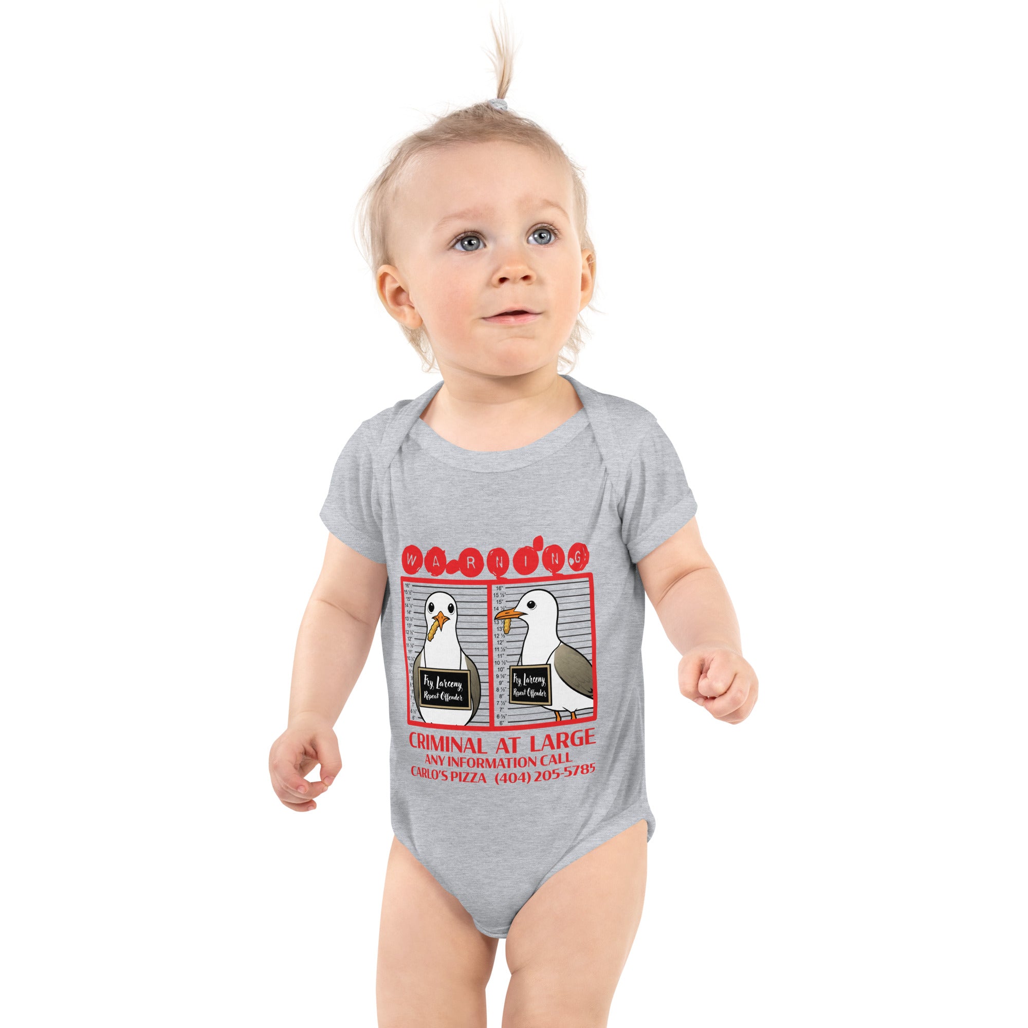 "Criminal At Large" heather grey baby short sleeve onesie on toddler model, featuring seagull "WARNING" mugshot graphic with "Fry Larceny, Repeat Offender" police lineup – 17th & Surf x Carlo's Pizza