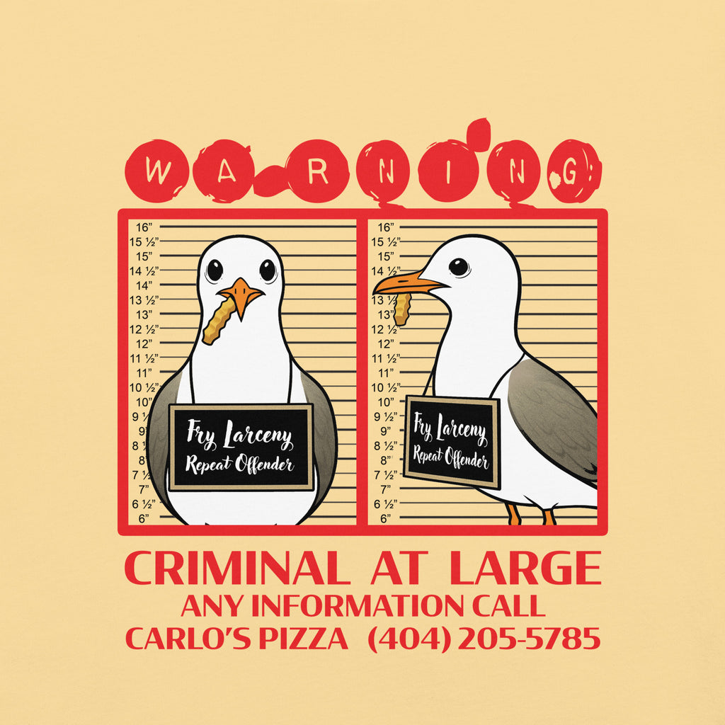 "Criminal At Large" pale yellow garment-dyed heavyweight tee, front flat lay, featuring seagull "WARNING" mugshot graphic with "Fry Larceny, Repeat Offender" police lineup – 17th & Surf x Carlo's Pizza