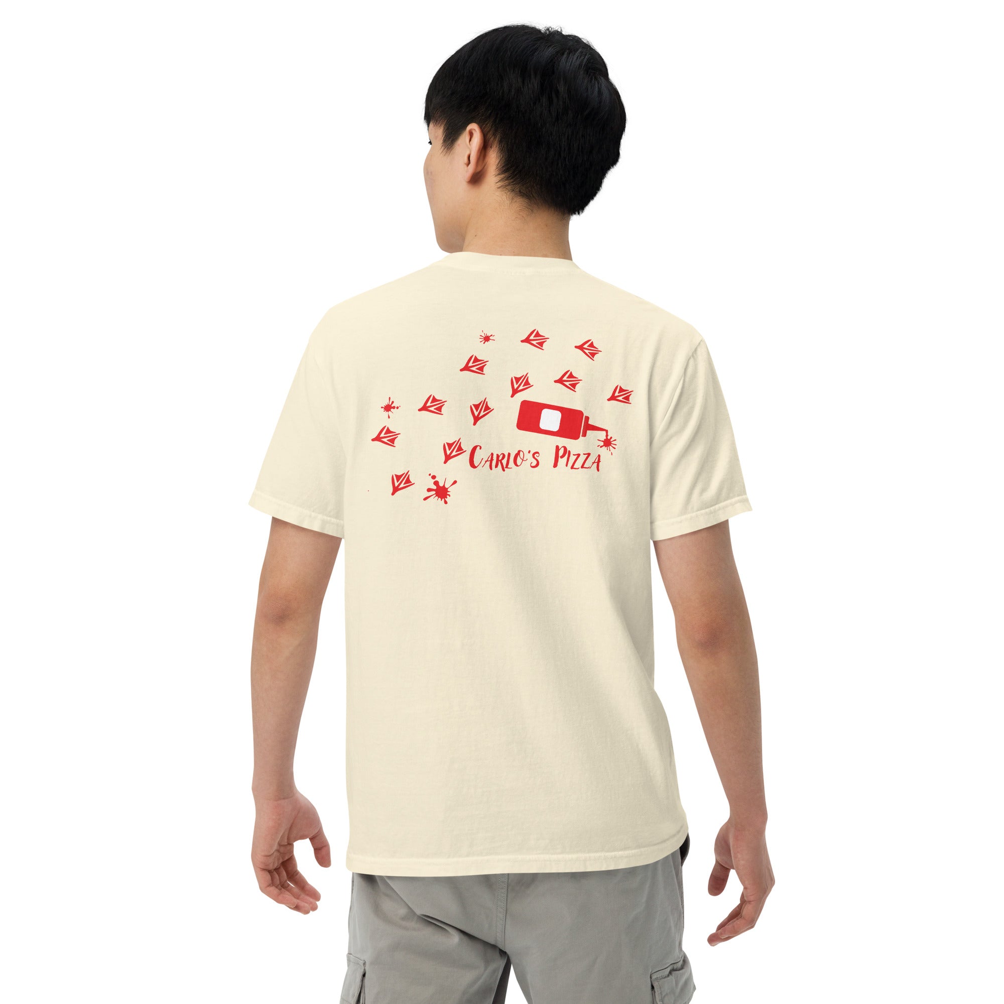 "Criminal At Large" ivory garment-dyed heavyweight tee on male model, back view, featuring red seagull footprint trail and Carlo's Pizza ketchup bottle design – 17th & Surf x Carlo's Pizza