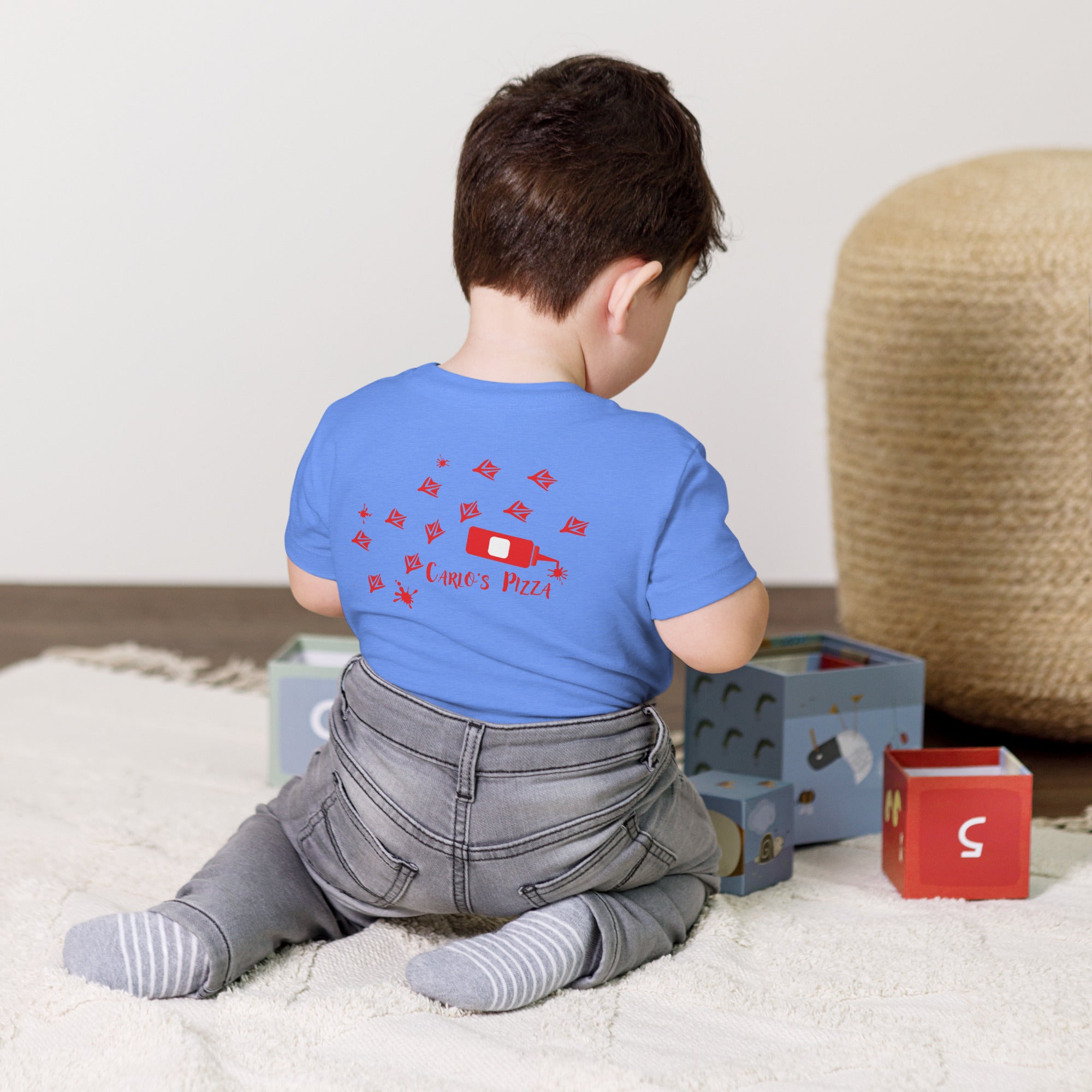 "Criminal At Large" columbia blue toddler tee on toddler model, back view, featuring red seagull footprint trail and Carlo's Pizza ketchup bottle design – 17th & Surf x Carlo's Pizza