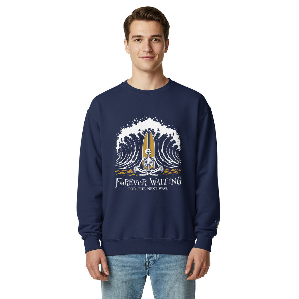 "Forever Waiting For The Next Wave" crewneck sweatshirt, True Navy, second front view, featuring a meditating skeleton surfer, board planted upright behind him, sitting cross-legged on the shore as breakers roll in on either side – 17th & Surf