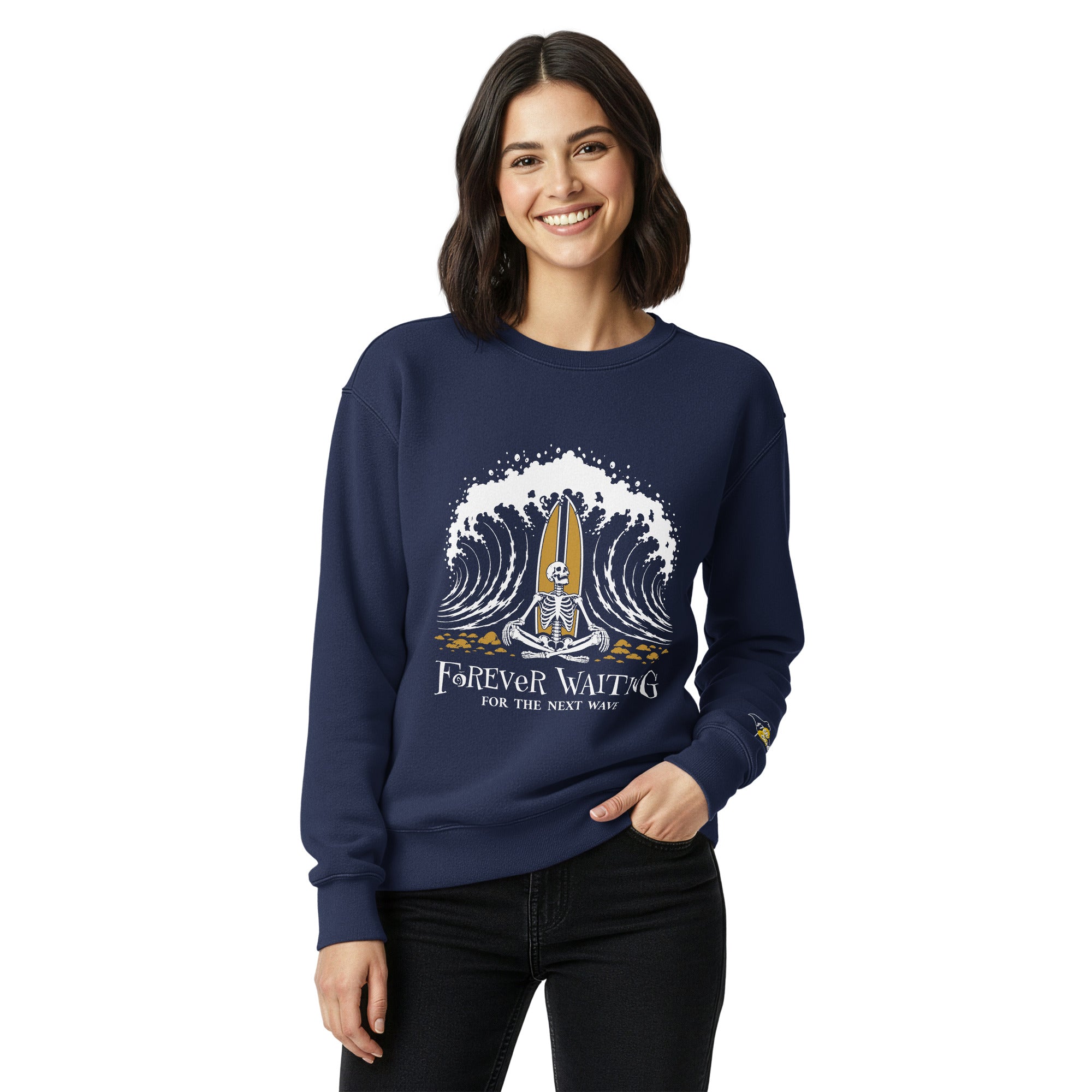 "Forever Waiting For The Next Wave" crewneck sweatshirt, True Navy, third front view, featuring a meditating skeleton surfer, board planted upright behind him, sitting cross-legged on the shore as breakers roll in on either side – 17th & Surf