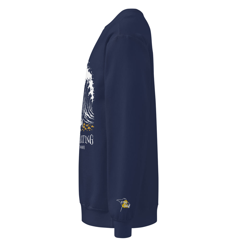 "Forever Waiting For The Next Wave" crewneck sweatshirt, True Navy, left side view, featuring a meditating skeleton surfer, board planted upright behind him, sitting cross-legged on the shore as breakers roll in on either side – 17th & Surf