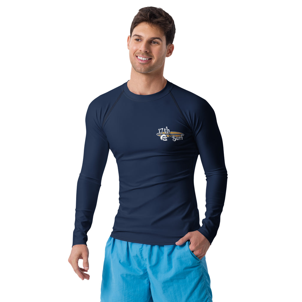 "Forever Waiting For The Next Wave" rash guard, third front view, featuring a meditating skeleton surfer, board planted upright behind him, sitting cross-legged on the shore as breakers roll in on either side – 17th & Surf