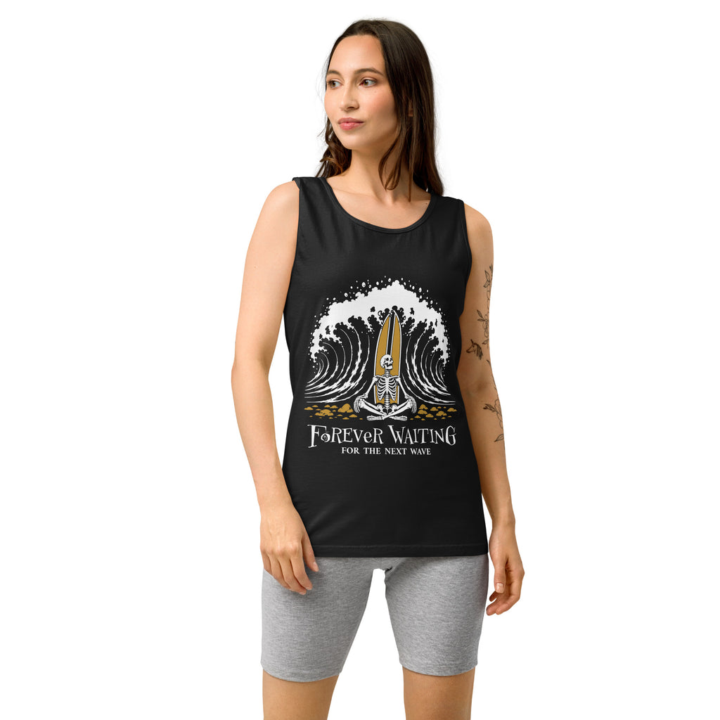 "Forever Waiting For The Next Wave" tank top, Black, third front view, featuring a meditating skeleton surfer, board planted upright behind him, sitting cross-legged on the shore as breakers roll in on either side – 17th & Surf