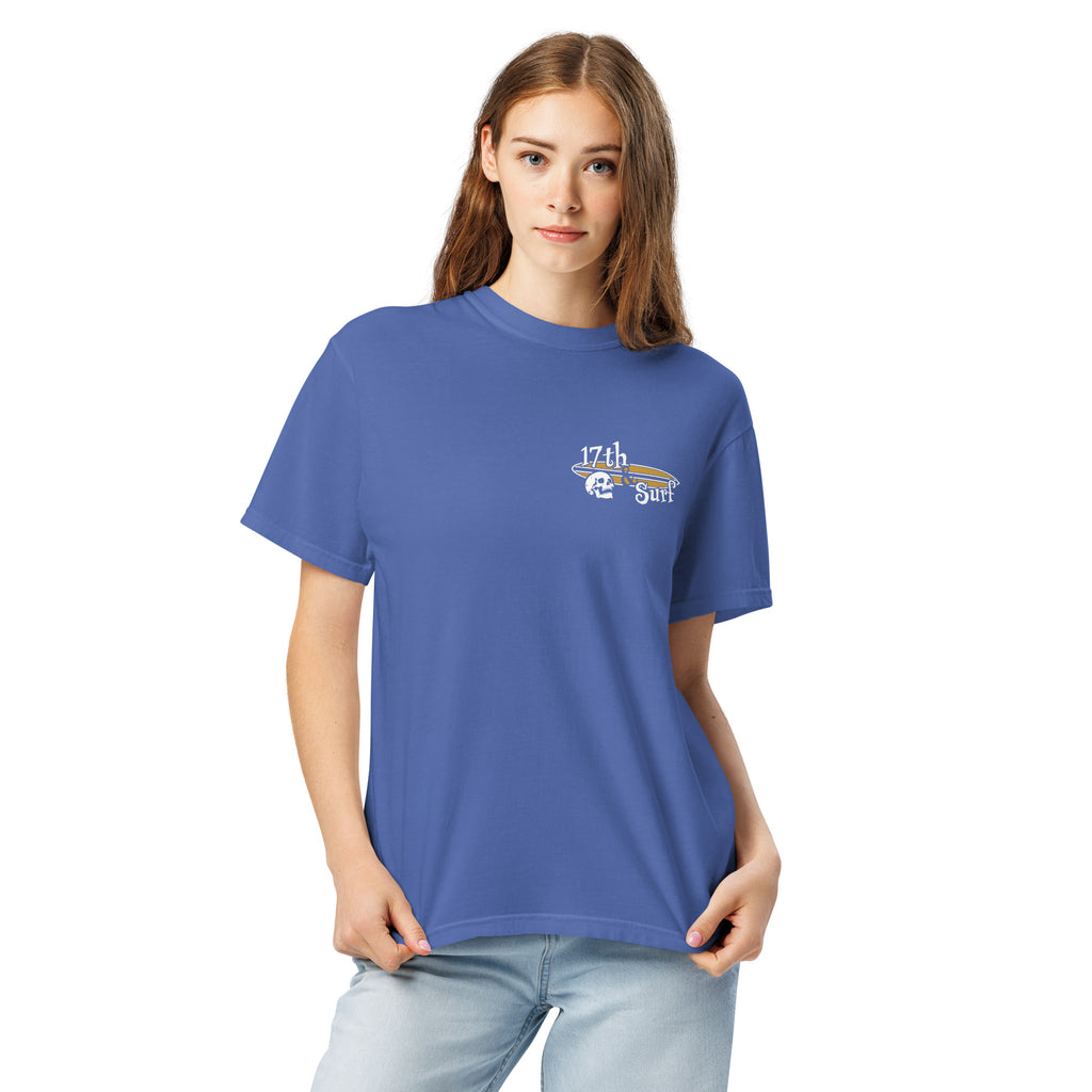 "Forever Waiting For The Next Wave" tee, Mystic Blue, second front view, featuring a meditating skeleton surfer, board planted upright behind him, sitting cross-legged on the shore as breakers roll in on either side – 17th & Surf