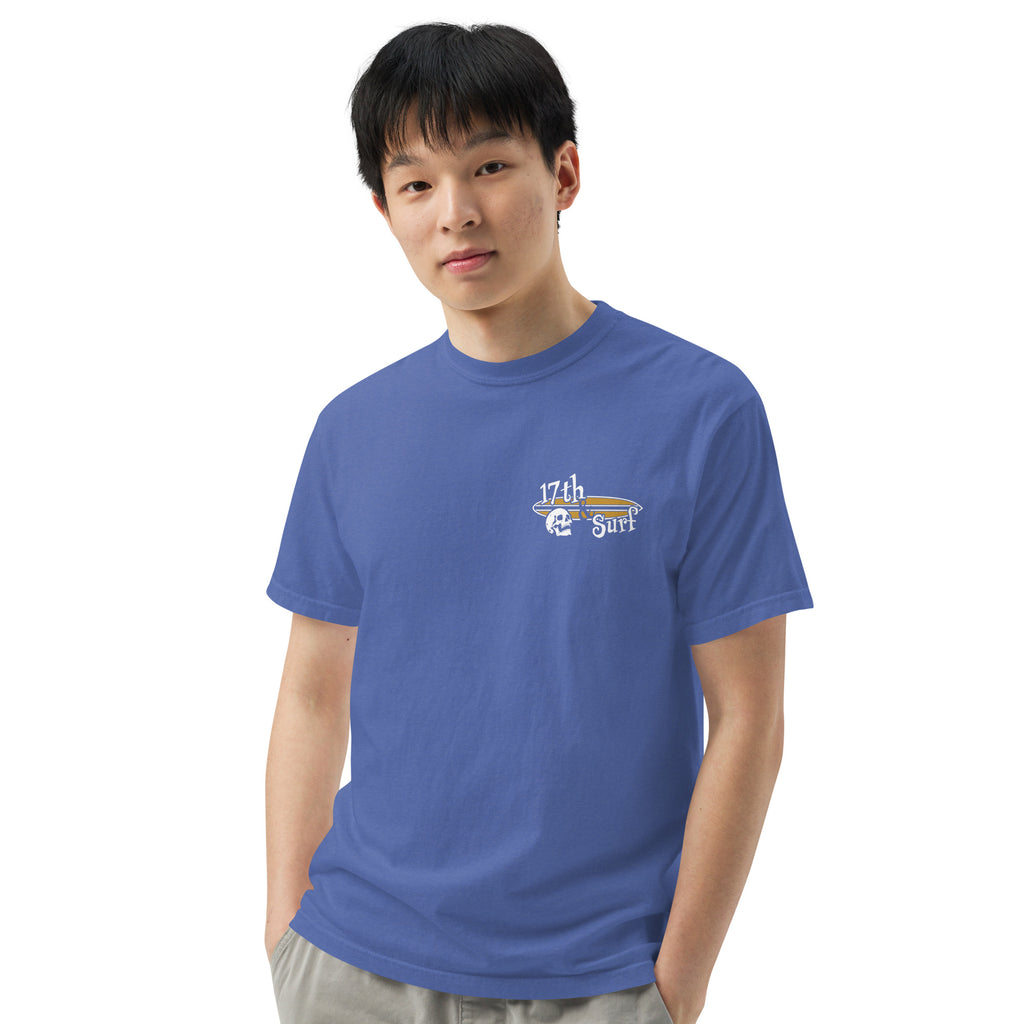 "Forever Waiting For The Next Wave" tee, Mystic Blue, third front view, featuring a meditating skeleton surfer, board planted upright behind him, sitting cross-legged on the shore as breakers roll in on either side – 17th & Surf
