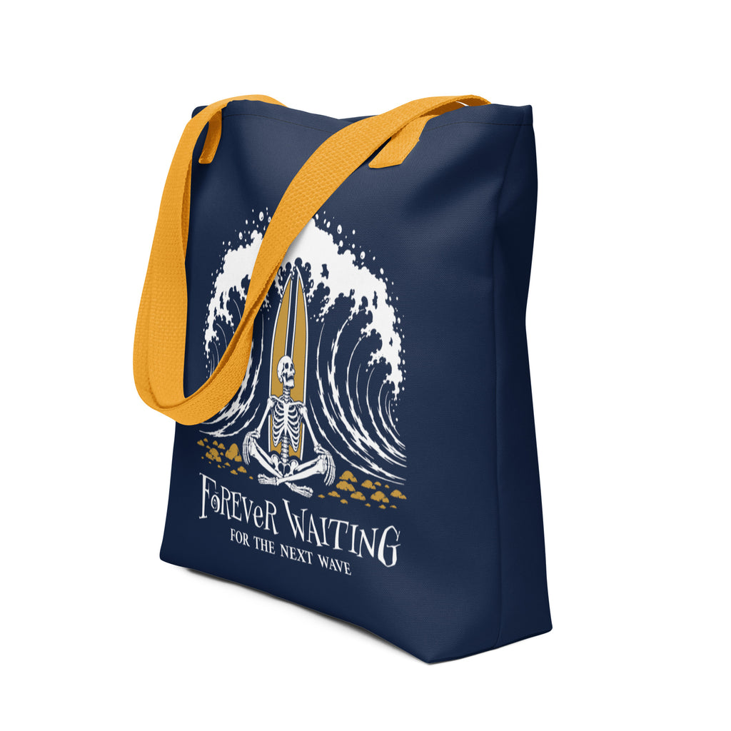 "Forever Waiting For The Next Wave" tote bag, second front view, featuring a meditating skeleton surfer, board planted upright behind him, sitting cross-legged on the shore as breakers roll in on either side – 17th & Surf