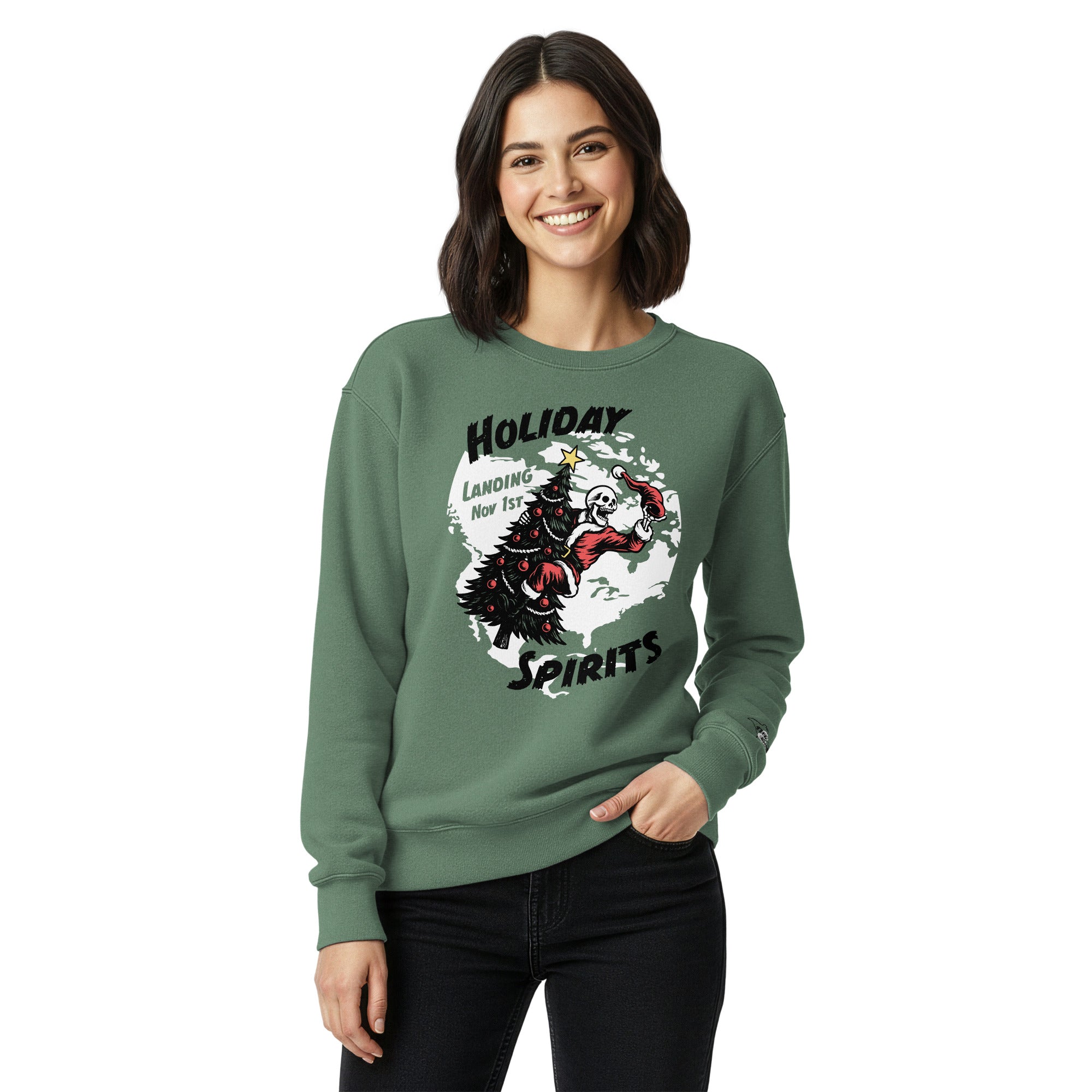 Model wearing "Holiday Spirits" heavyweight crewneck sweatshirt in light green, second front view featuring full color graphic of a skeleton Santa riding a decorated Christmas tree inside a white splatter map shape with arched "Holiday" and "Spirits" text and "Landing Nov 1st" – 17th & Surf