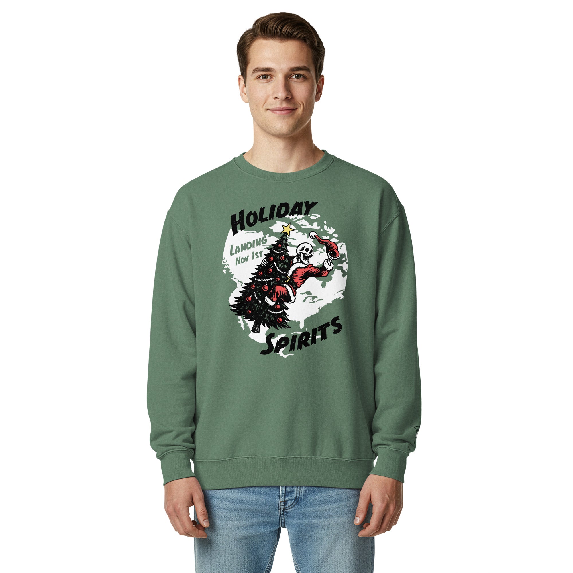 Model wearing "Holiday Spirits" heavyweight crewneck sweatshirt in light green, third front view featuring full color graphic of a skeleton Santa riding a decorated Christmas tree inside a white splatter map shape with arched "Holiday" and "Spirits" text and "Landing Nov 1st" – 17th & Surf