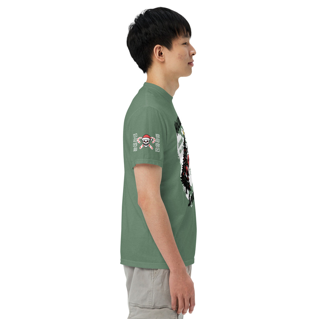 Model wearing "Holiday Spirits" front print garment-dyed heavyweight t-shirt in light green, right angle view featuring full color graphic of a skeleton Santa riding a decorated Christmas tree with arched "Holiday" and "Spirits" text – 17th & Surf
