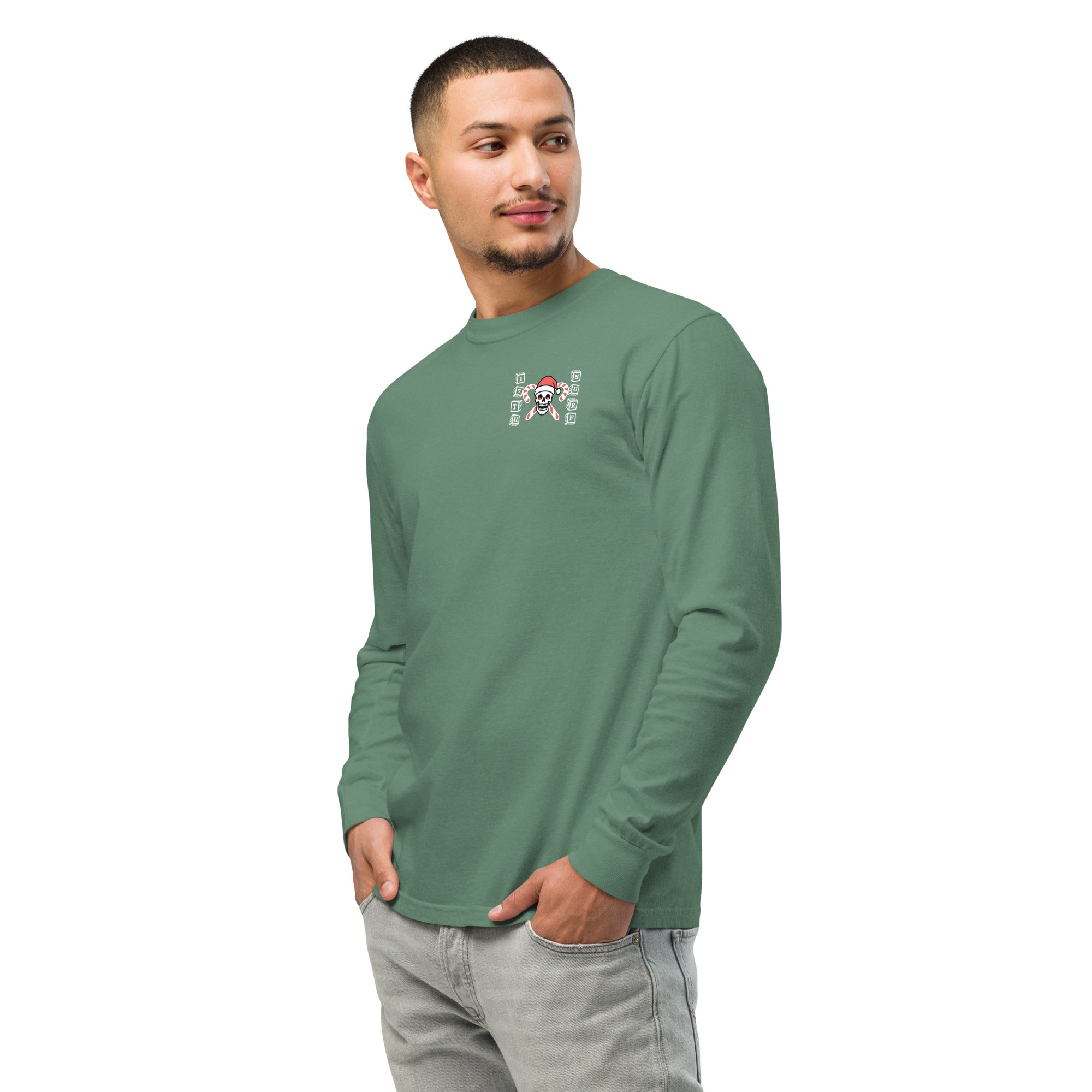 Model wearing "Holiday Spirits" garment-dyed heavyweight long sleeve shirt in sage green with small "17th & Surf" candy cane crossbones skull chest logo, front angle view – 17th & Surf
