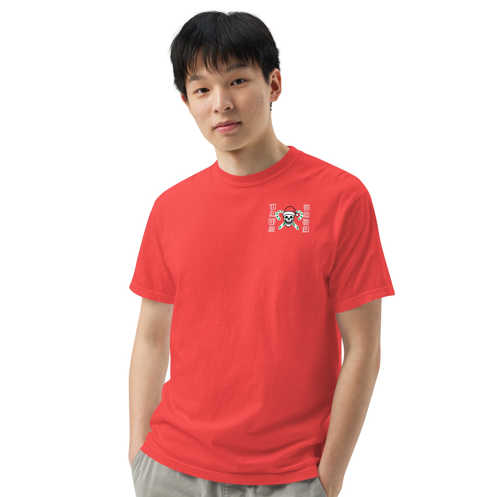 Model wearing "Holiday Spirits" garment-dyed heavyweight t-shirt in red with small "17th & Surf" candy cane crossbones skull chest logo, front view – 17th & Surf