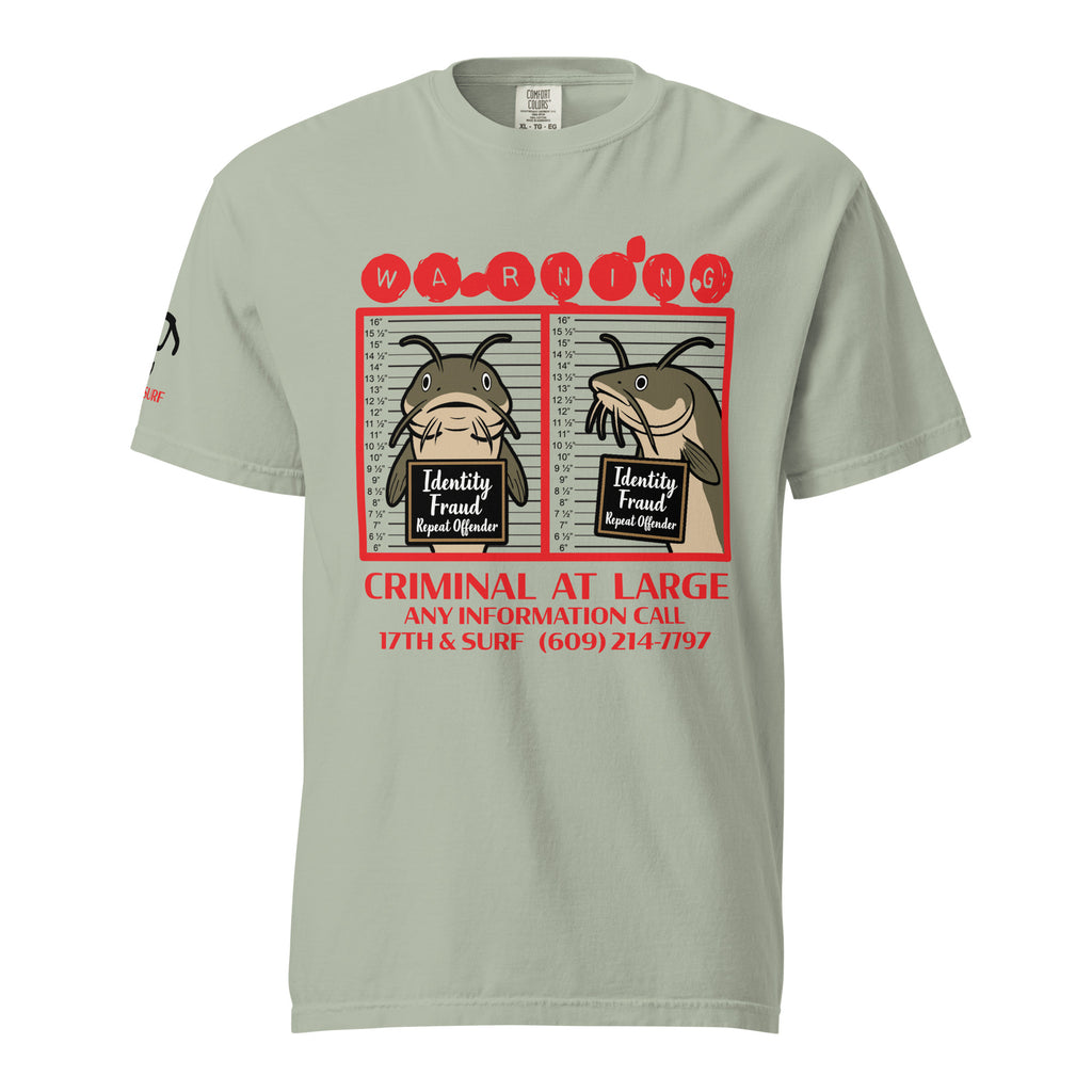 "Identity Fraud" bay garment-dyed heavyweight tee, front flat lay, featuring catfish "WARNING" mugshot graphic with "Identity Fraud, Repeat Offender" police lineup – 17th & Surf