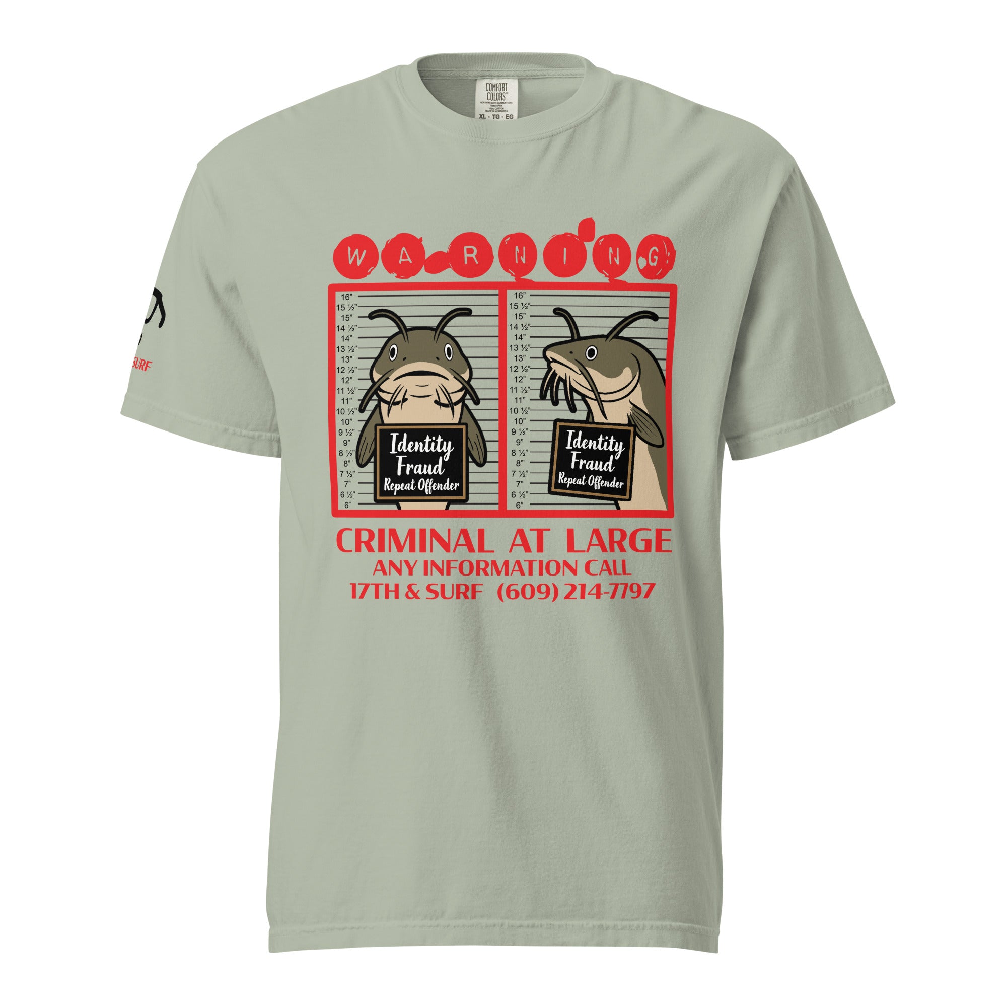 "Identity Fraud" bay garment-dyed heavyweight tee, front flat lay, featuring catfish "WARNING" mugshot graphic with "Identity Fraud, Repeat Offender" police lineup – 17th & Surf