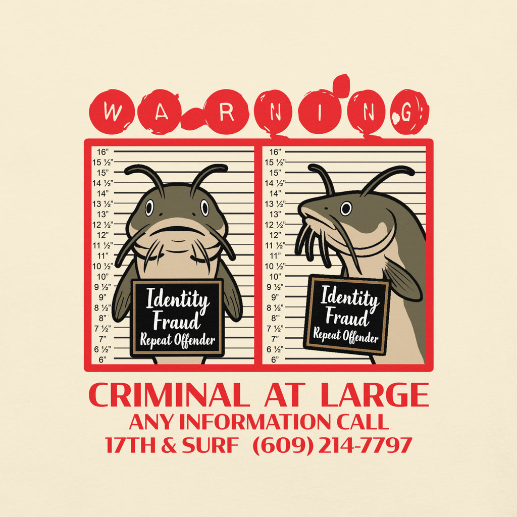 "Identity Fraud" ivory garment-dyed heavyweight tee, close-up of catfish "WARNING" mugshot graphic with "Identity Fraud, Repeat Offender" police lineup – 17th & Surf