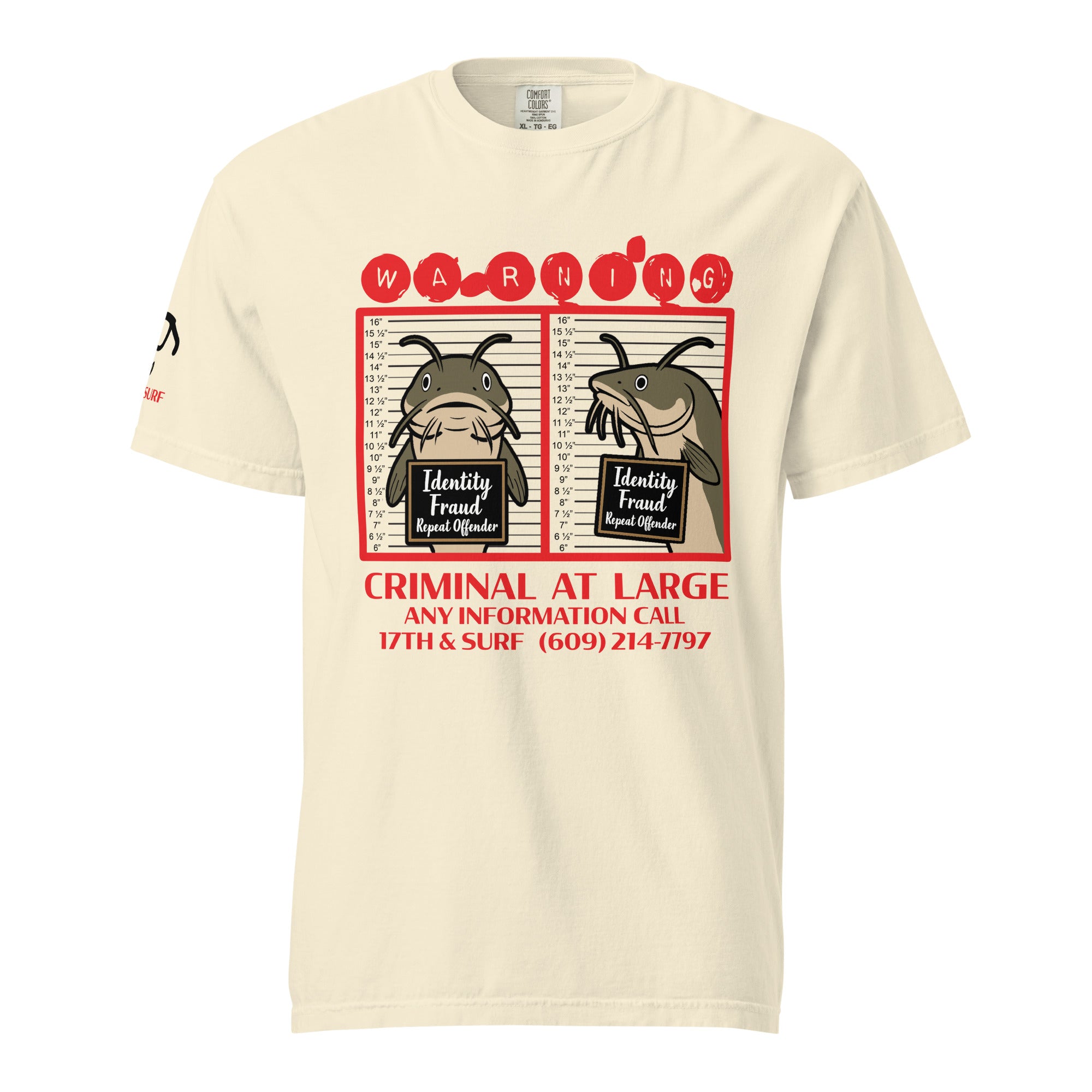 "Identity Fraud" ivory garment-dyed heavyweight tee, front flat lay, featuring catfish "WARNING" mugshot graphic with "Identity Fraud, Repeat Offender" police lineup – 17th & Surf