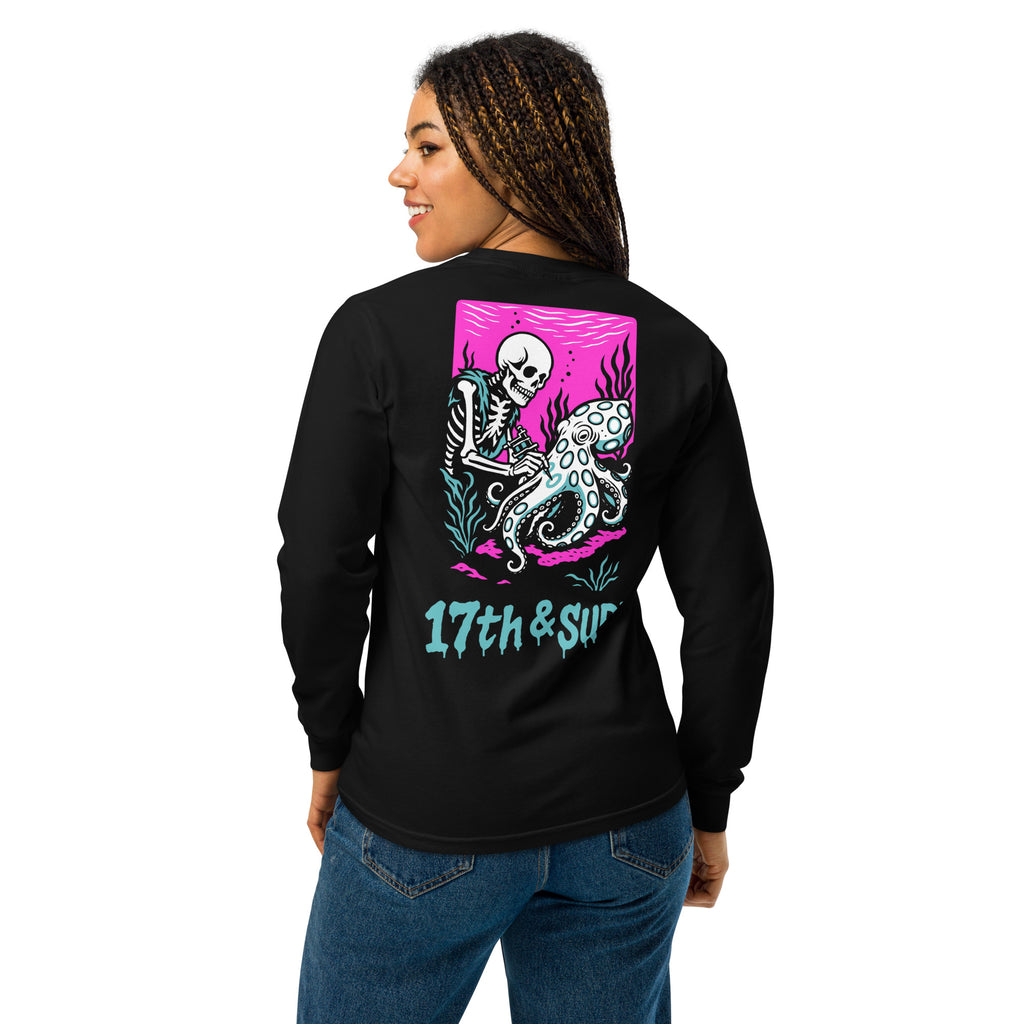 "Inked" garment-dyed heavyweight long sleeve back angle in black featuring skeleton tattooing an octopus graphic with "17th & Surf" text on pink background – 17th & Surf