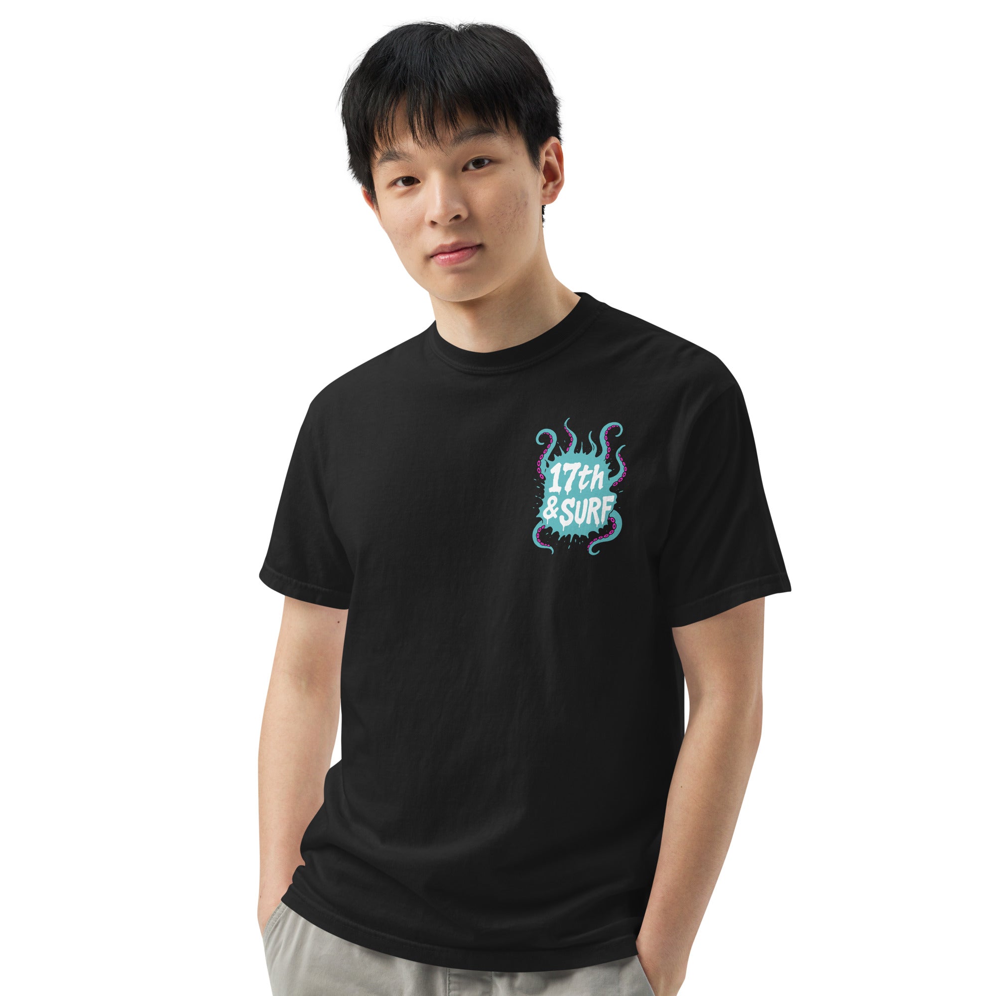 "Inked" garment-dyed heavyweight tee front view on male model in black showing small skeleton-and-tentacle "17th & Surf" chest logo – 17th & Surf