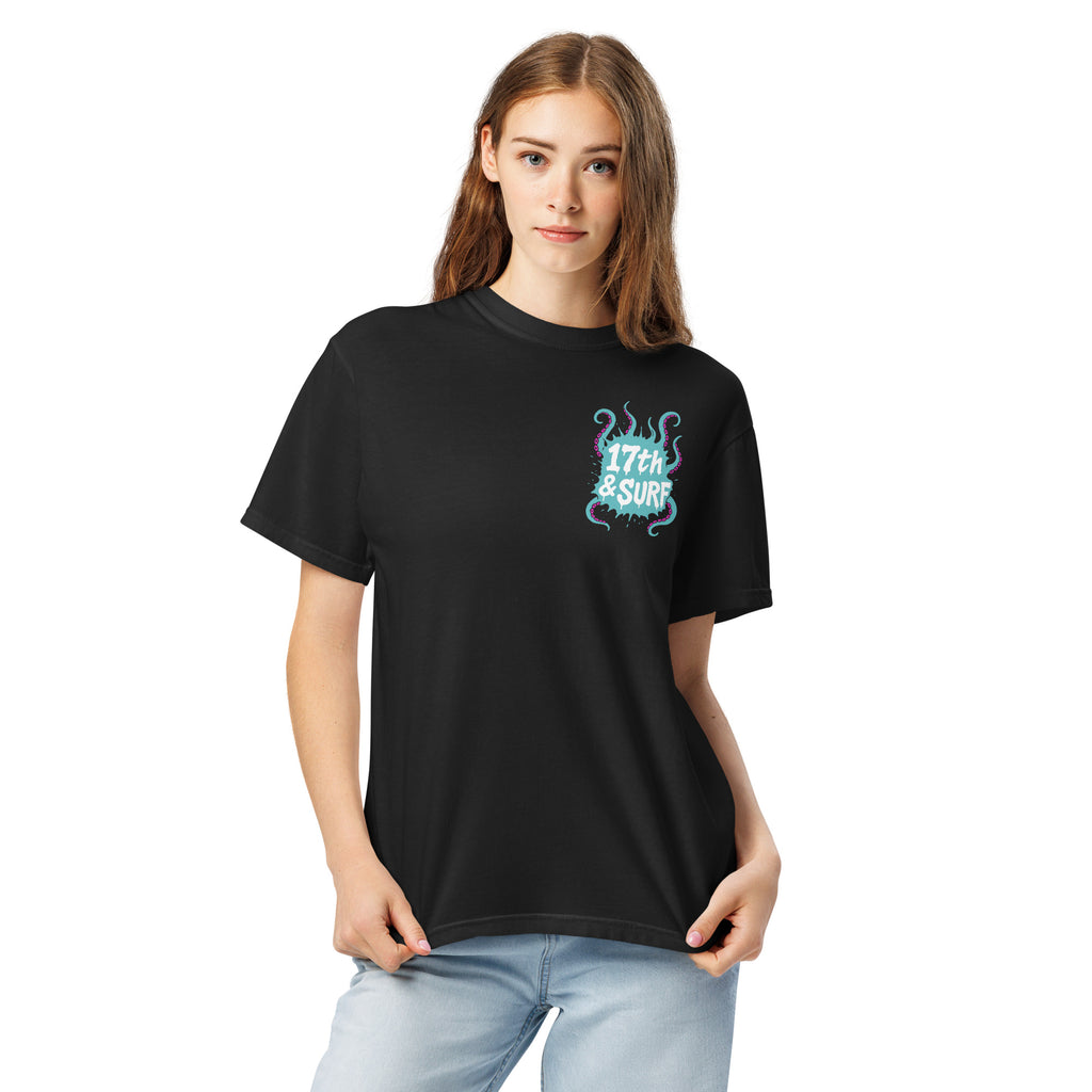"Inked" garment-dyed heavyweight tee front view on female model in black showing small skeleton-and-tentacle "17th & Surf" chest logo – 17th & Surf