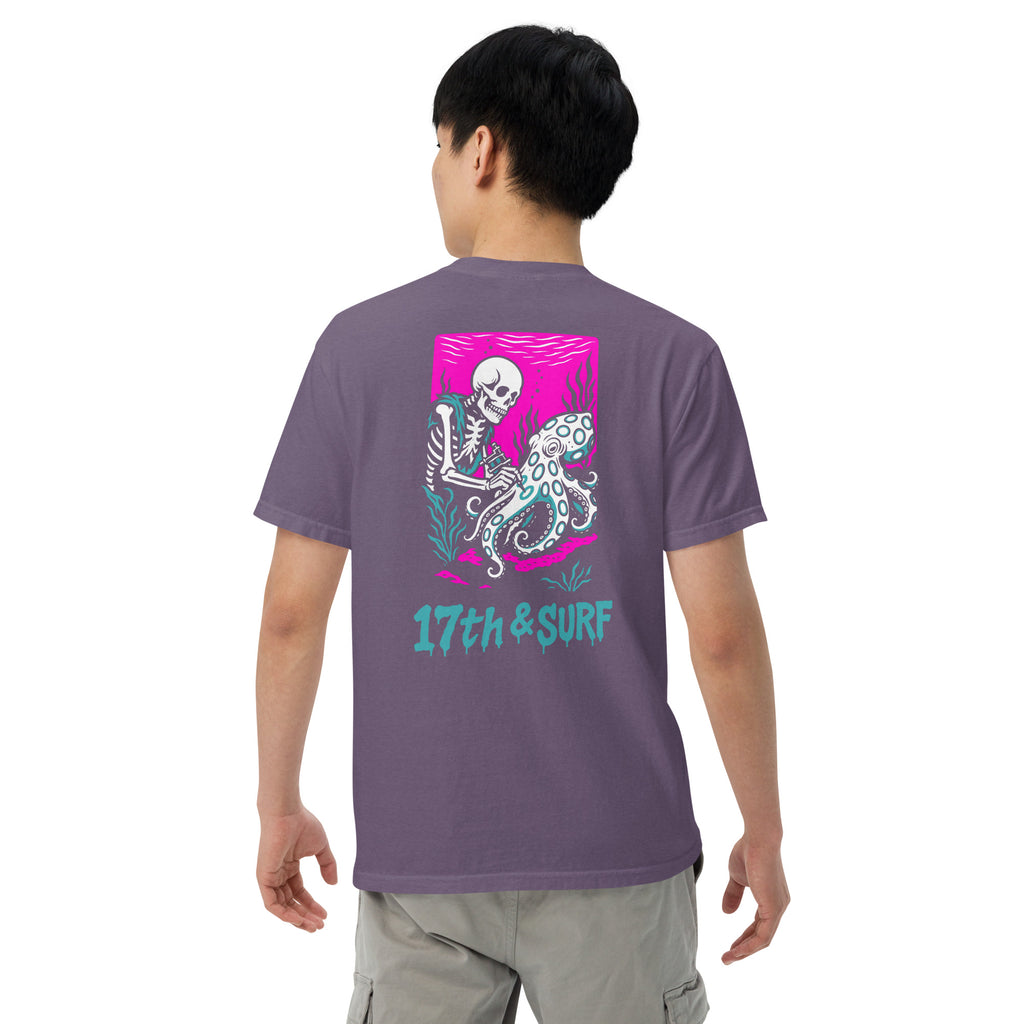 "Inked" garment-dyed heavyweight tee back second angle in grape featuring skeleton tattooing an octopus graphic with "17th & Surf" text on pink background – 17th & Surf