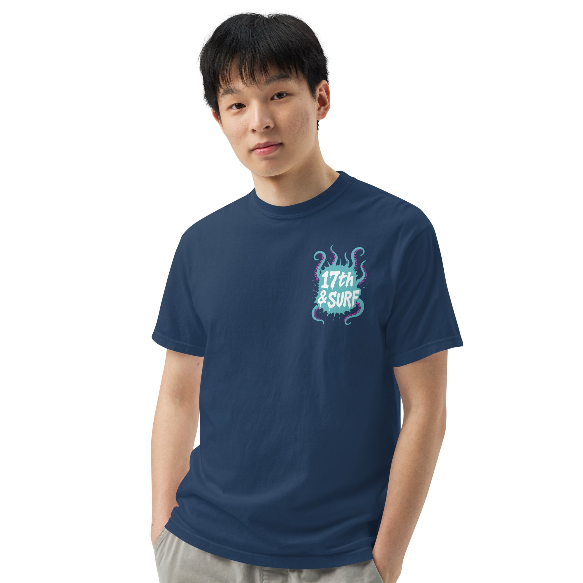 "Inked" garment-dyed heavyweight tee front view on male model in true navy showing small skeleton-and-tentacle "17th & Surf" chest logo – 17th & Surf