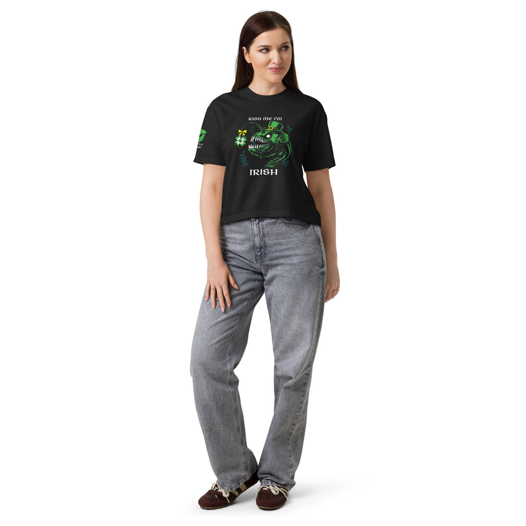 "Kiss Me I'm Irish" Anglerfish black heavyweight boxy tee on female model, front view, featuring the green leprechaun anglerfish with shamrock lure and "KISS ME I'M IRISH" text – 17th & Surf