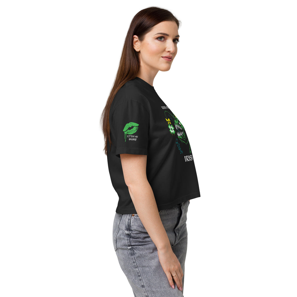 "Kiss Me I'm Irish" Anglerfish black heavyweight boxy tee on female model, side profile view showcasing the dripping-lips "17TH & SURF" sleeve logo alongside the "IRISH" text of the anglerfish design – 17th & Surf