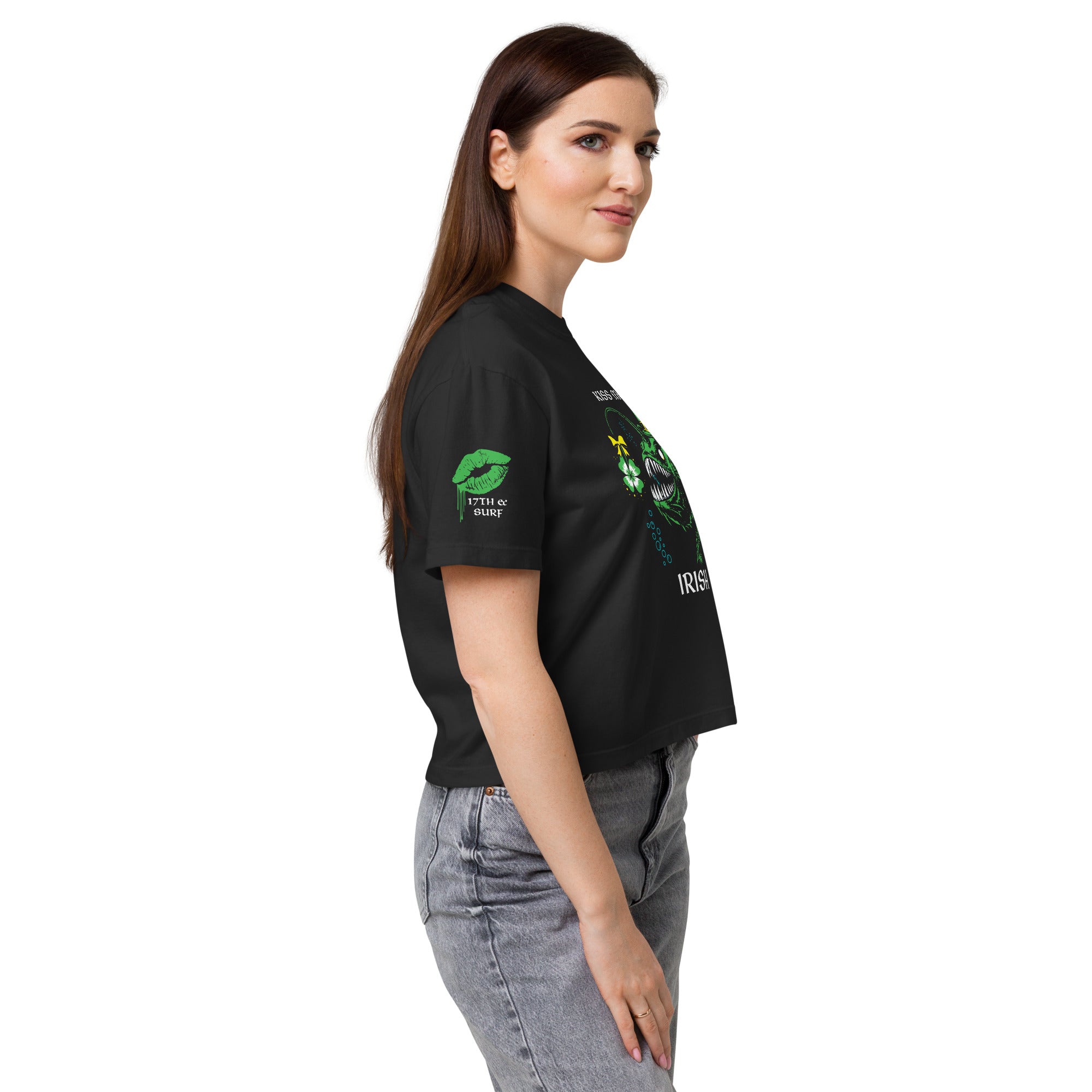 "Kiss Me I'm Irish" Anglerfish black heavyweight boxy tee on female model, side profile view showcasing the dripping-lips "17TH & SURF" sleeve logo alongside the "IRISH" text of the anglerfish design – 17th & Surf